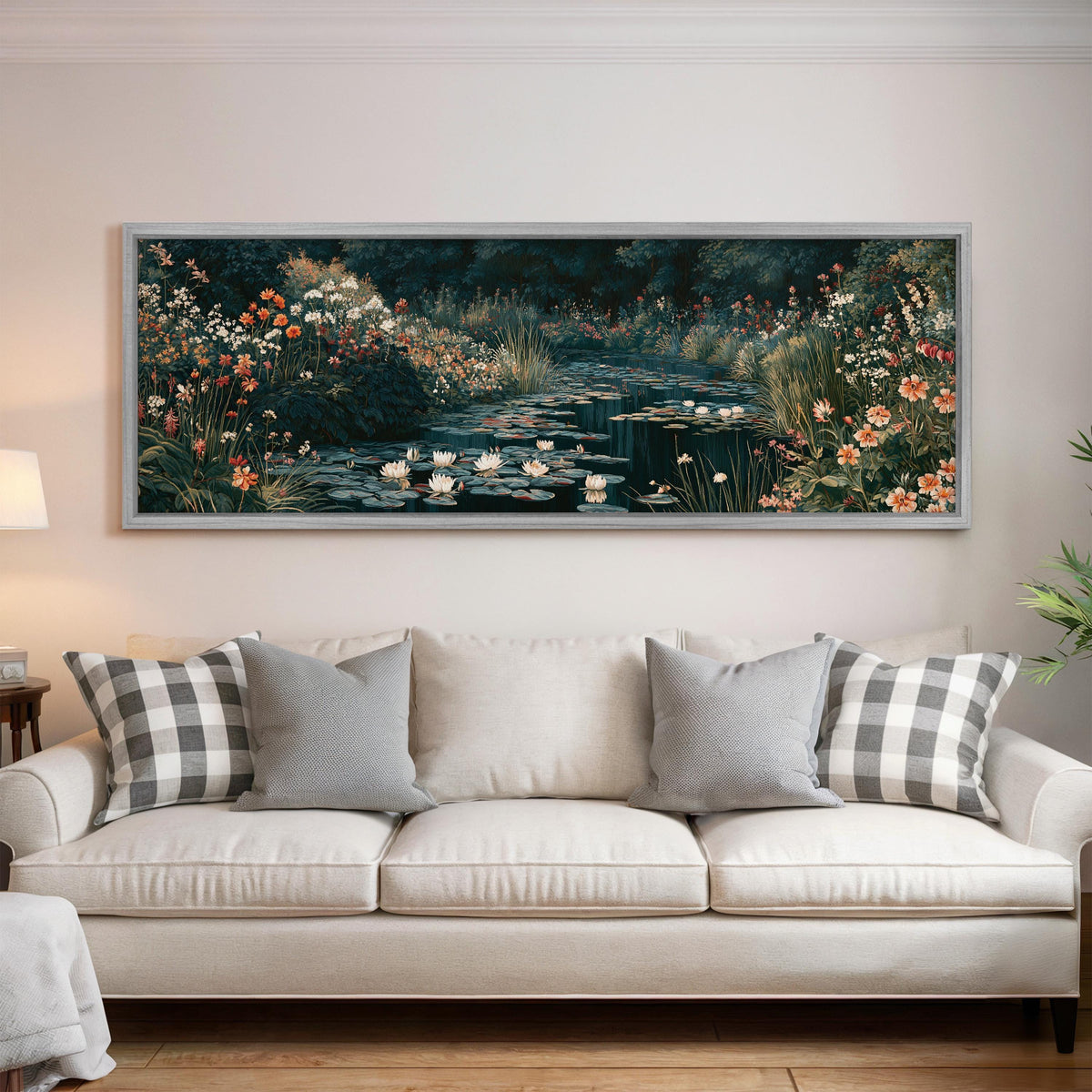Lily pond surrounded by wildflowers panoramic canvas print above a white sofa in a bright living room