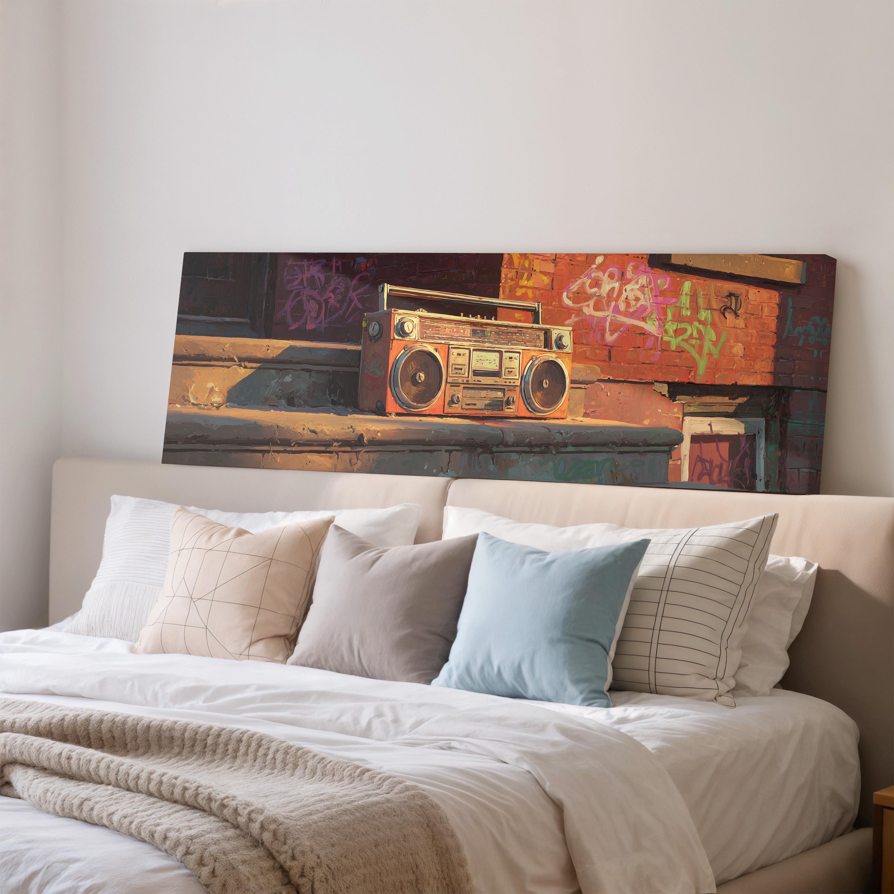 a large canvas print of a vintage boombox on a wall above a bed with white bedding and pillows.