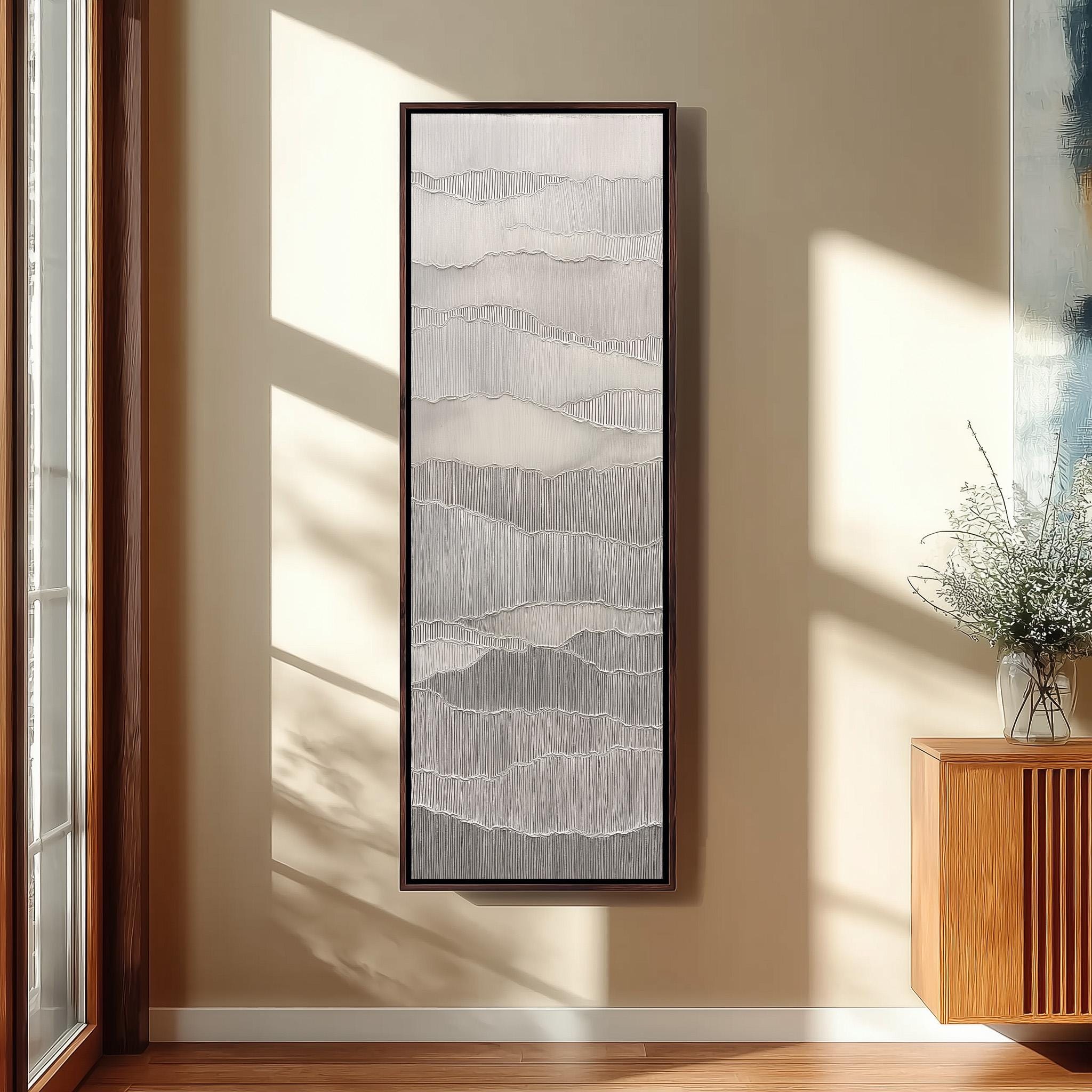 a large, abstract painting hanging on a wall in a room with wooden furniture and a window.