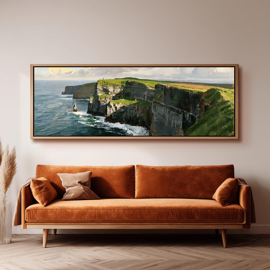 Sunlit sea cliffs with a sea stack long horizontal canvas print above a sofa in a living room