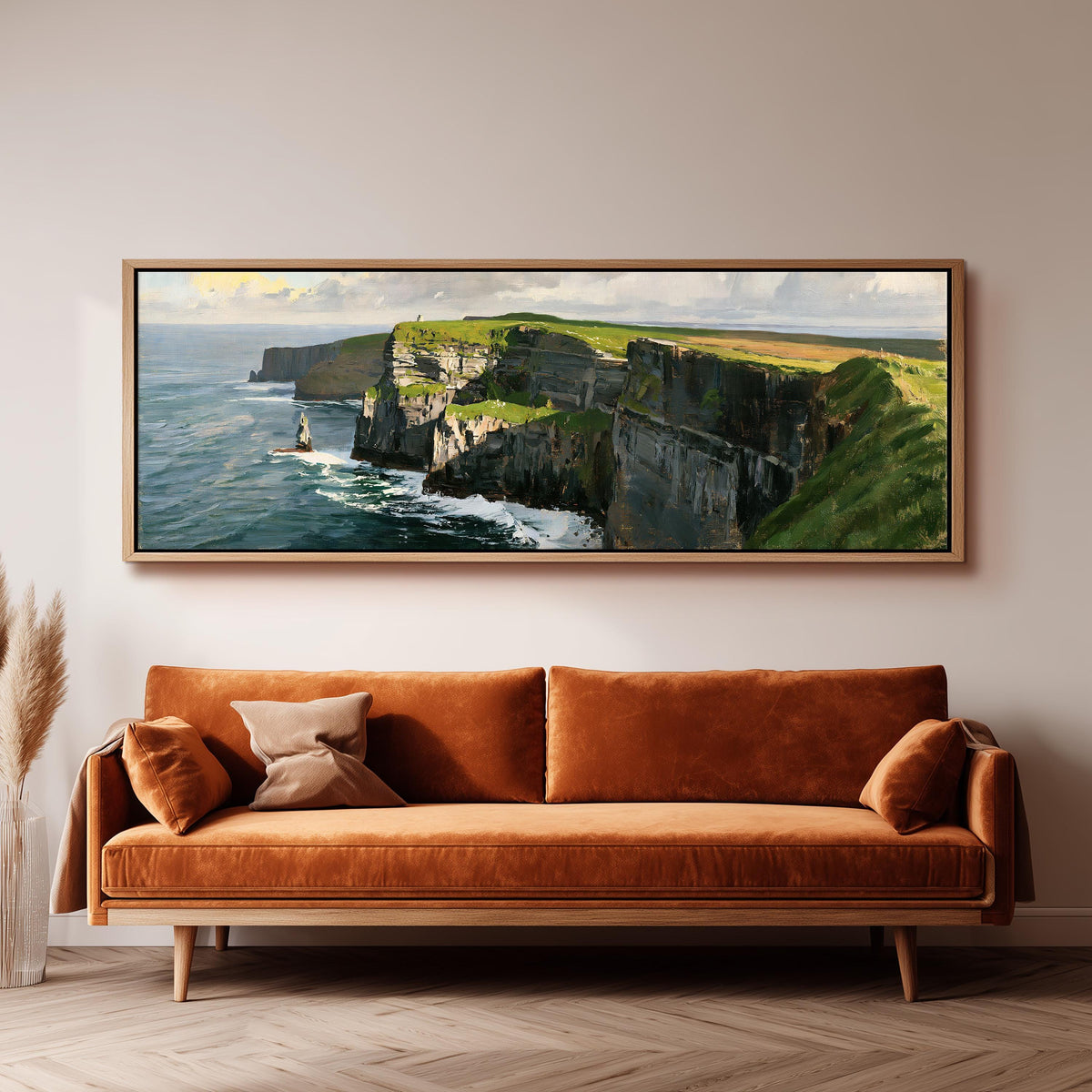 Sunlit sea cliffs with a sea stack panoramic canvas print above a sofa in a living room