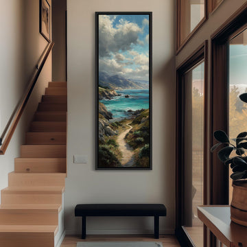 a large painting of a coastal landscape hanging on the wall of a hallway. The painting depicts a winding path leading to a serene body of water, surrounded by mountains and lush greenery. The hallway is well-lit, with a wooden staircase and a bench in the foreground. The painting adds a sense of tranquility and natural beauty to the space.
