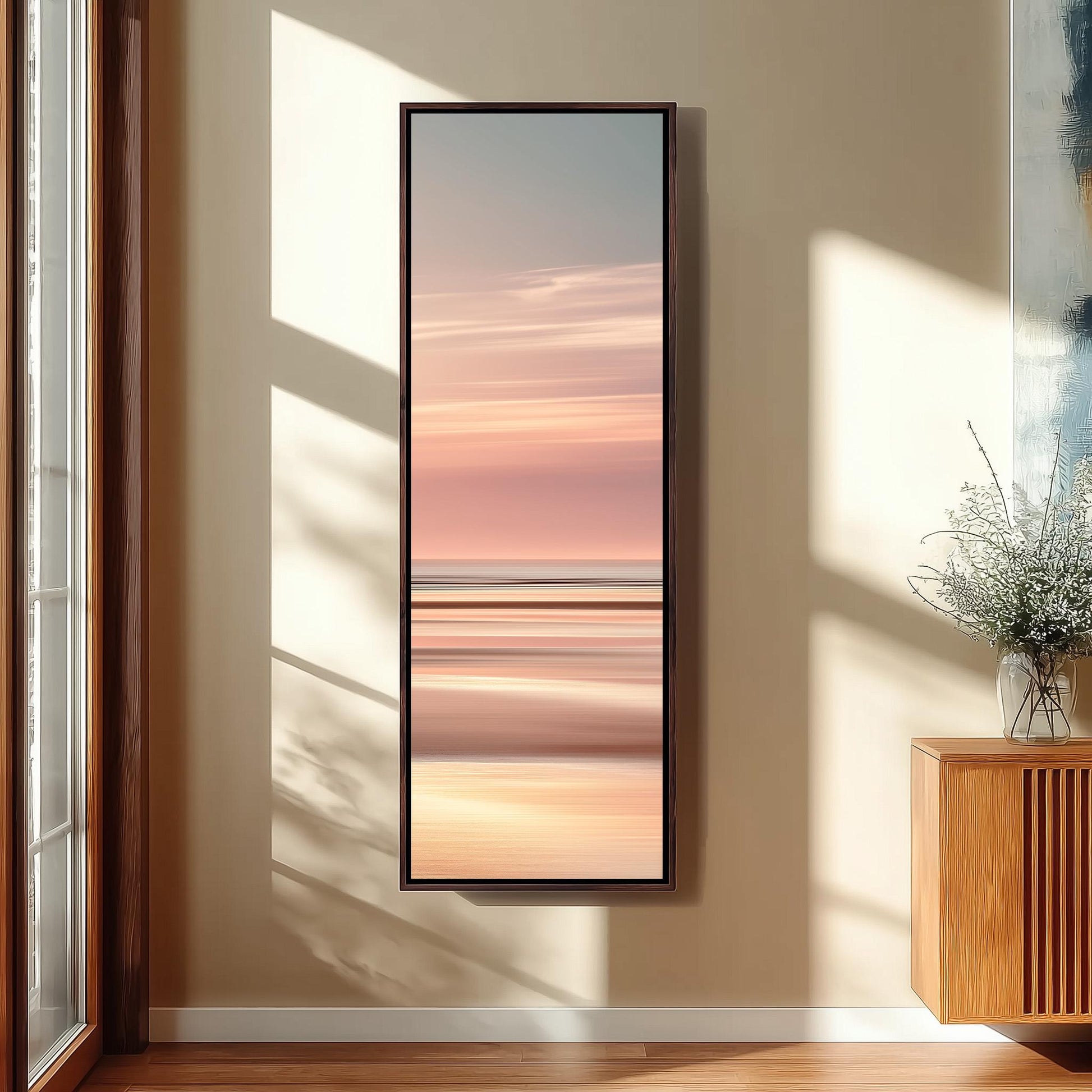 a large, rectangular painting hanging on a wall, depicting a serene landscape with a sunset over a body of water.