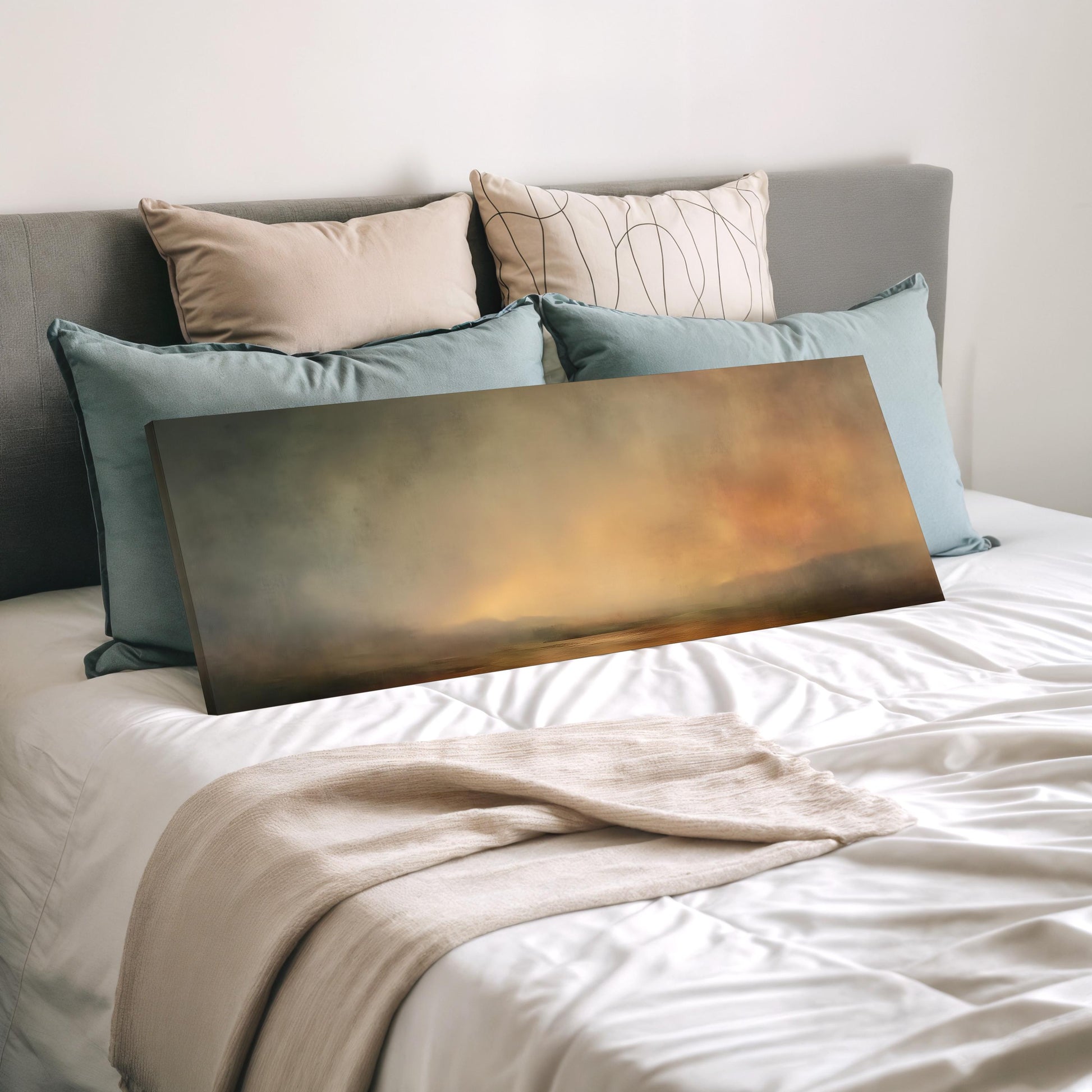 a bedroom with a bed covered in white sheets and a large painting or canvas resting on top of the bed.