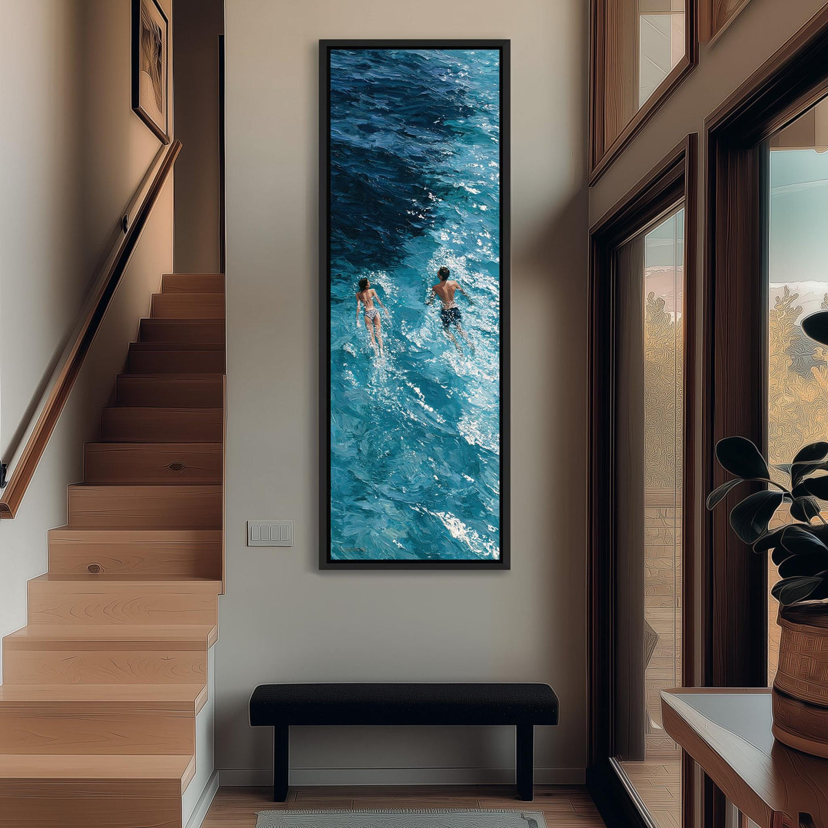 Two swimmers in deep blue waves tall narrow canvas print beside a staircase in an entryway