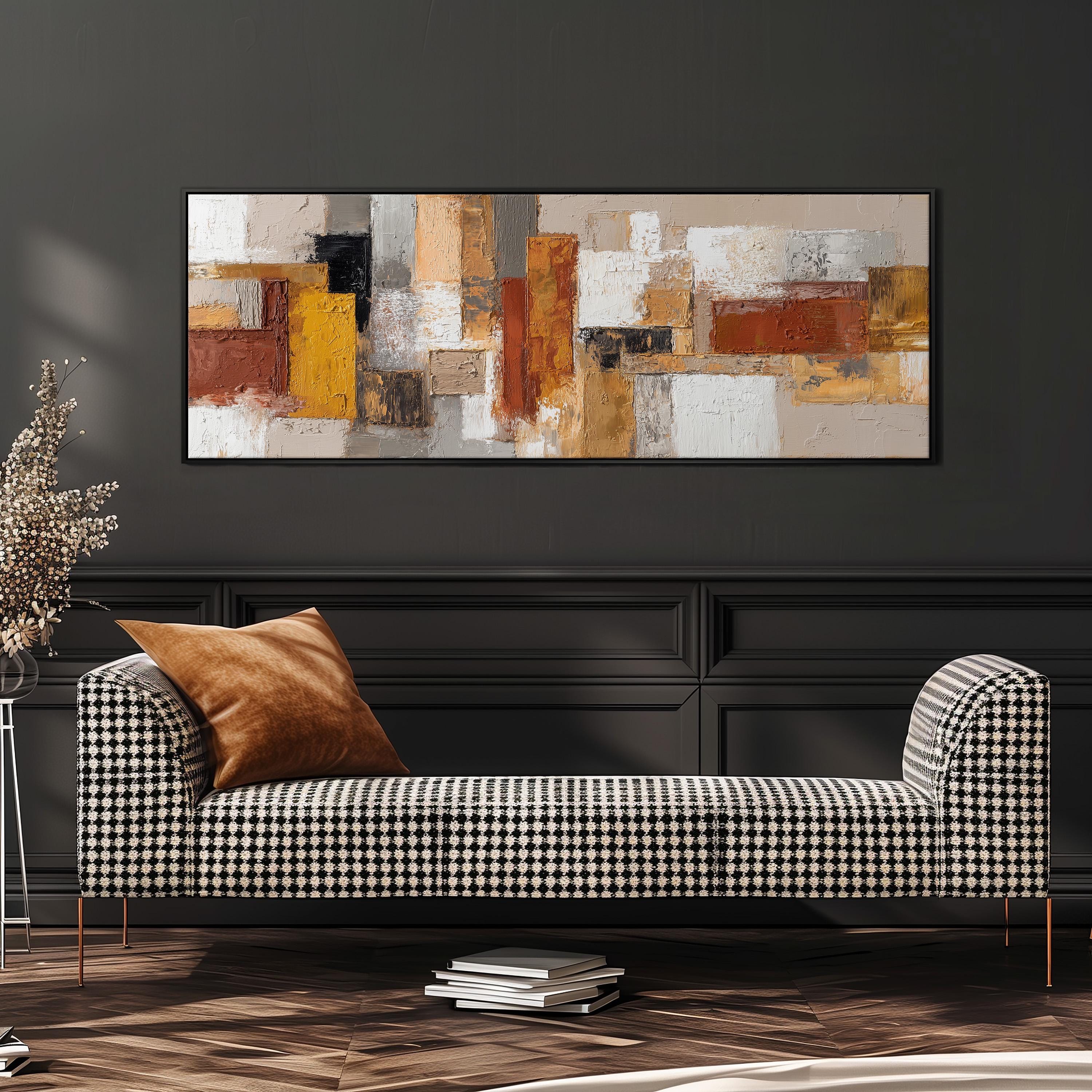 a modern living room with a black and white checkered sofa, a large abstract painting on the wall, and a stack of books on the floor.