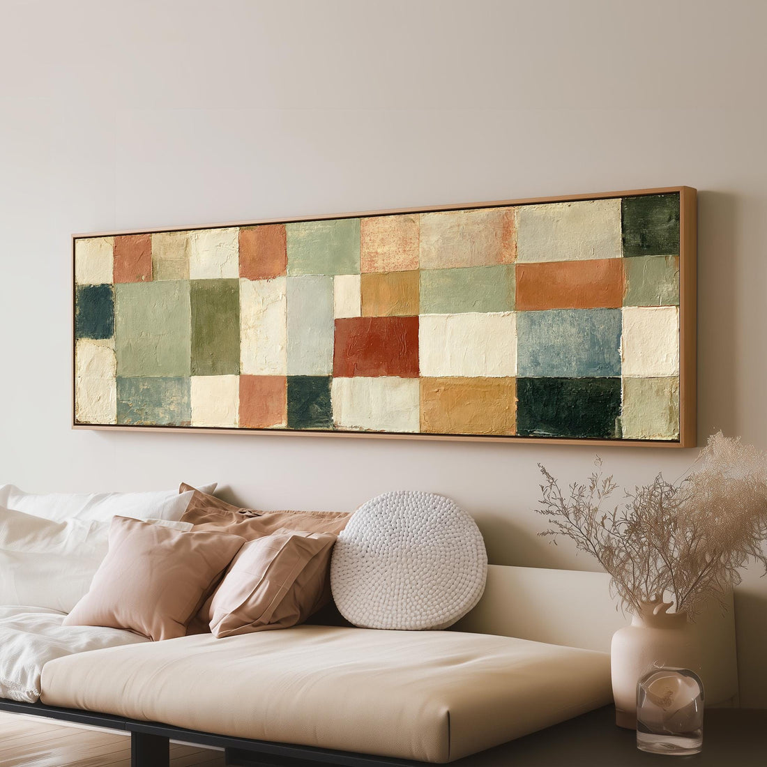 Earth tone patchwork squares long horizontal canvas print above a sofa in a living room
