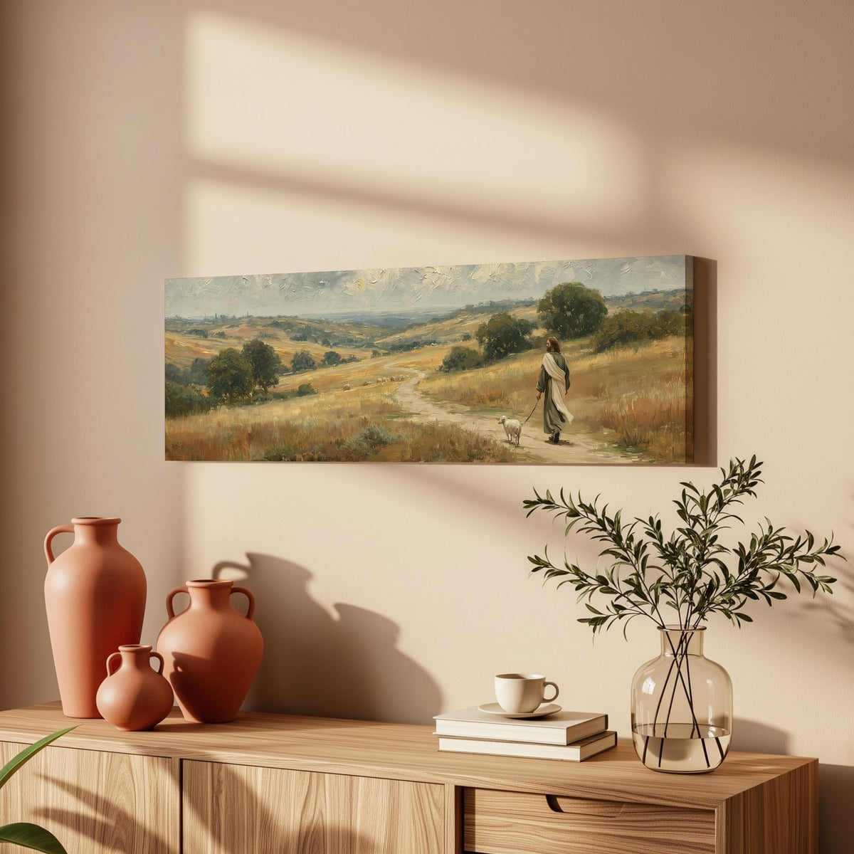 Jesus walking with a sheep on a golden hillside long horizontal canvas print above a wooden sideboard