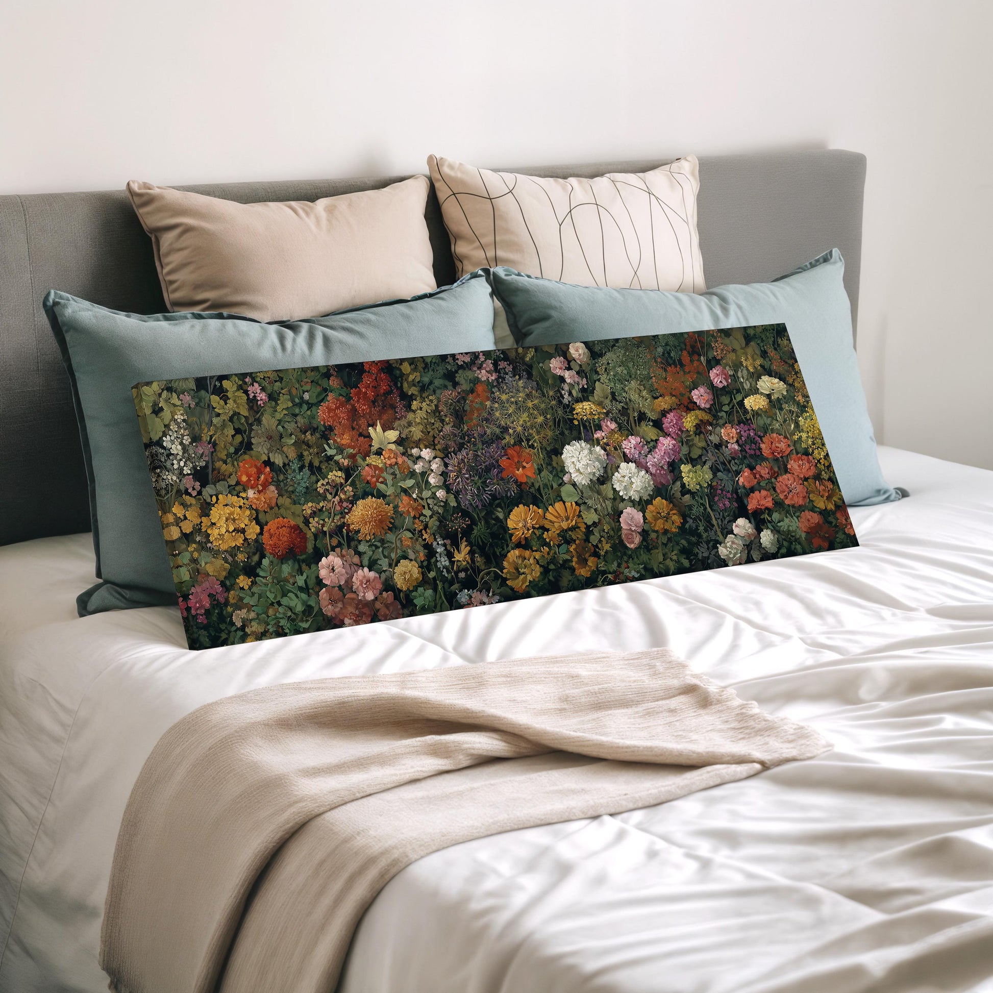 a bed with a large floral print or canvas on it, which appears to be a painting or photograph of a garden or floral arrangement. The bed is covered with white sheets and pillows, creating a cozy and inviting atmosphere.