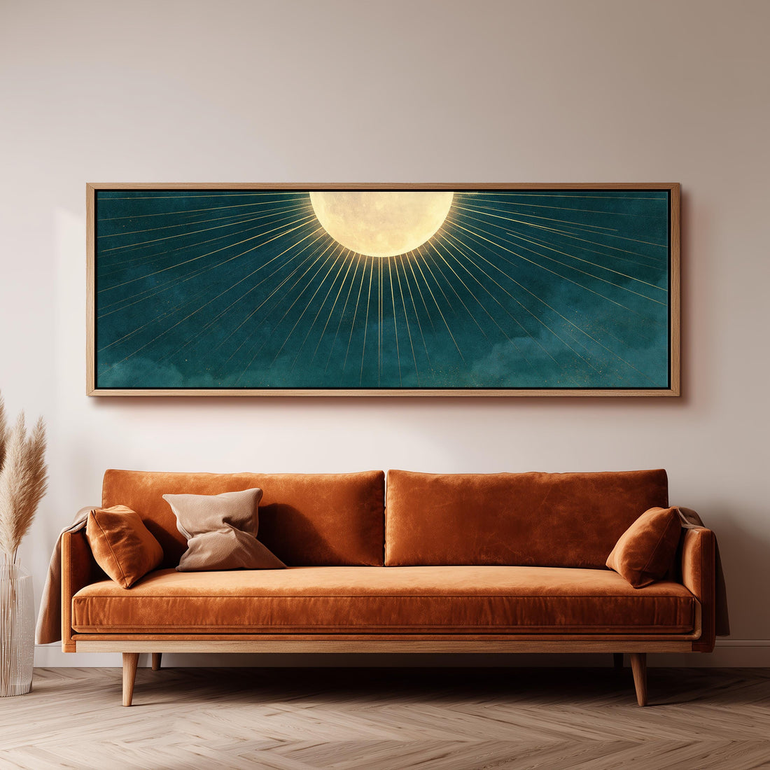 Golden sunburst moon on deep teal long horizontal canvas print above a sofa in a living room