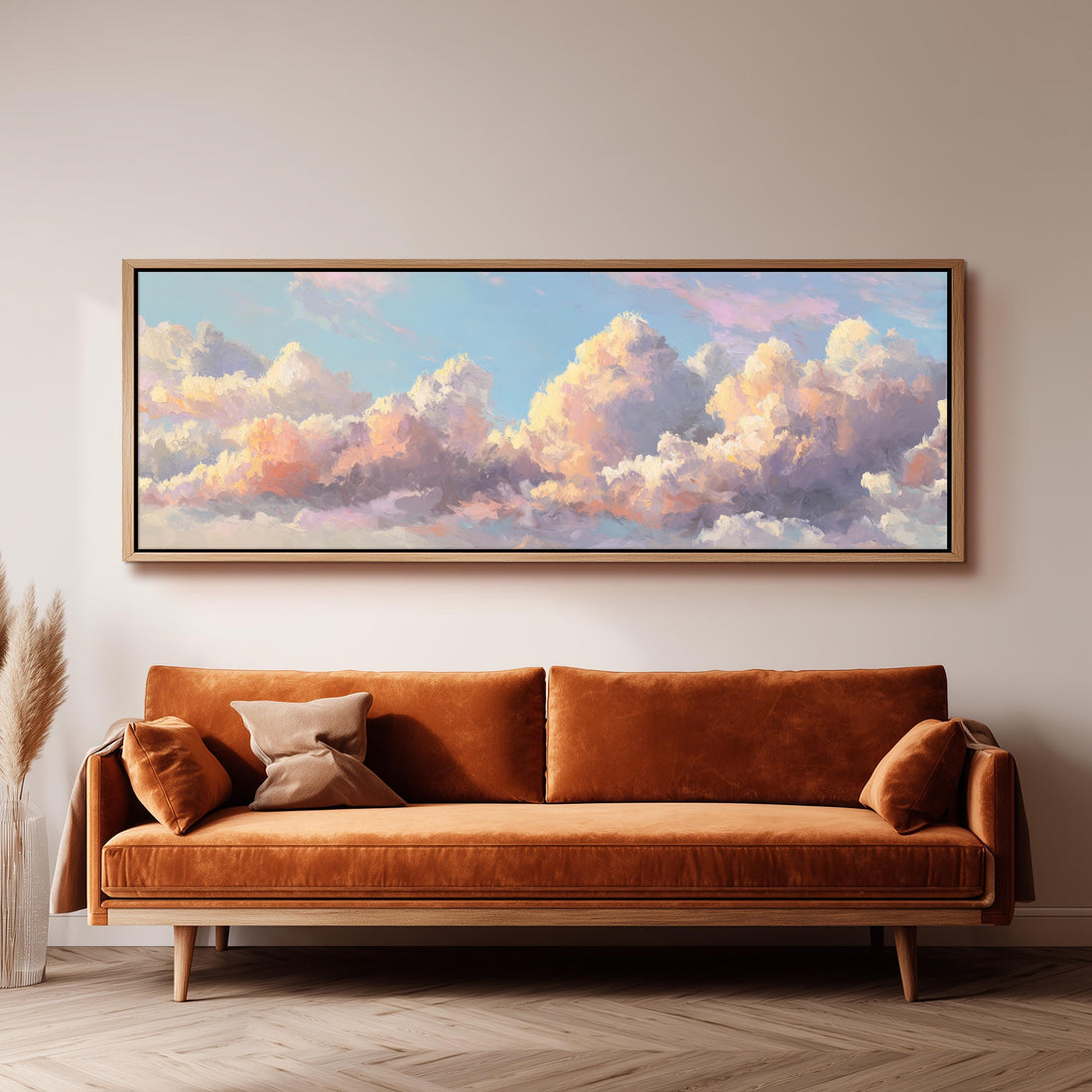 a large, framed painting of a cloudy sky hanging on a wall above a brown sofa.