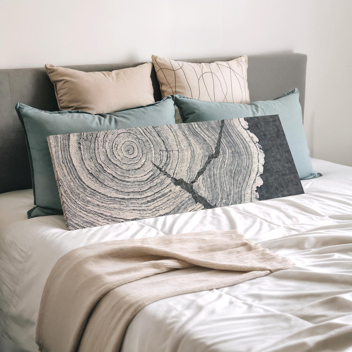Grey tree ring on linen texture wide panoramic canvas print laid on a bed to show its size