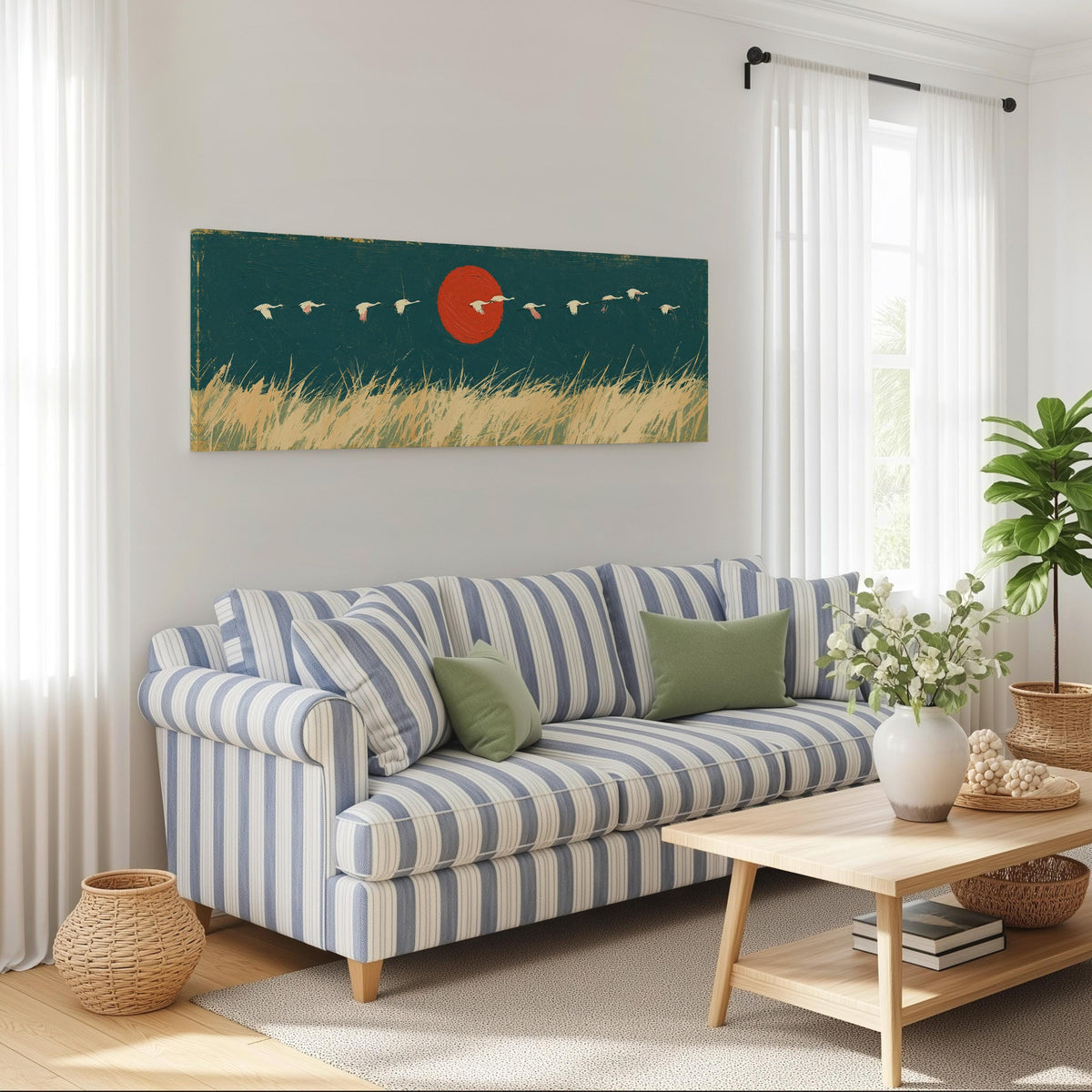 Bird flock over a prairie under a red sun long horizontal canvas print above a striped sofa in a coastal living room