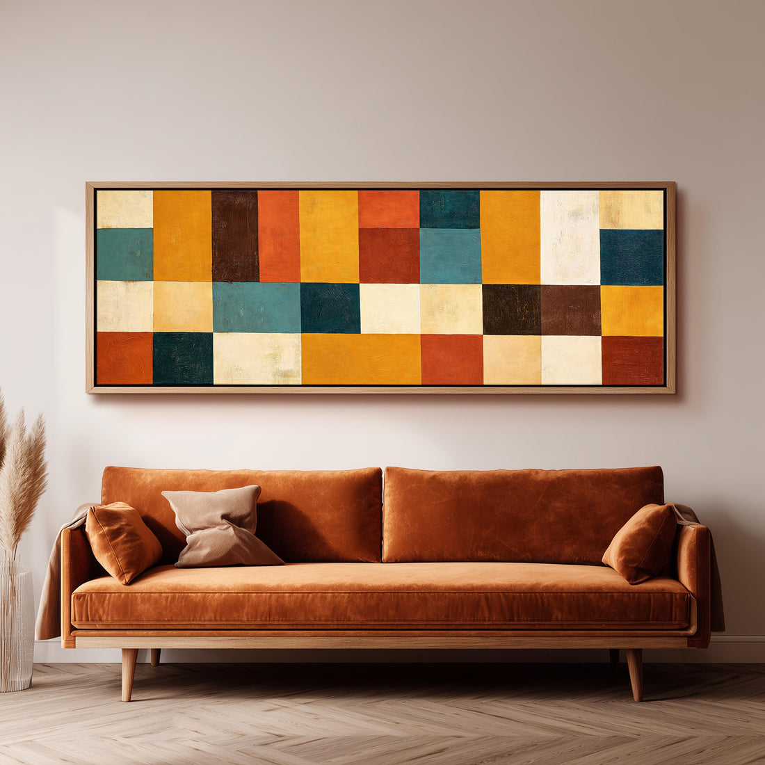Ochre, rust and teal patchwork blocks long horizontal canvas print above a sofa in a living room