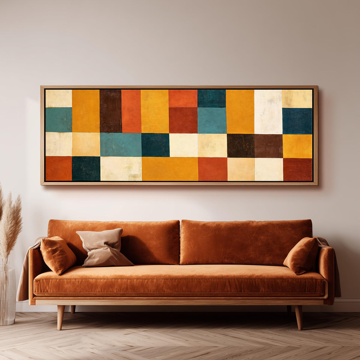 Ochre, rust and teal patchwork blocks long horizontal canvas print above a sofa in a living room