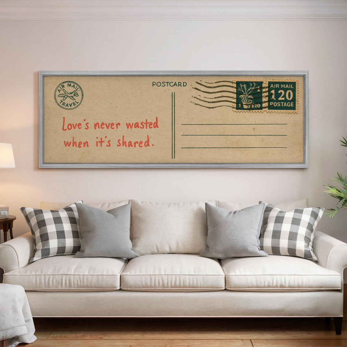 Vintage postcard with a love quote panoramic canvas print above a white sofa in a bright living room