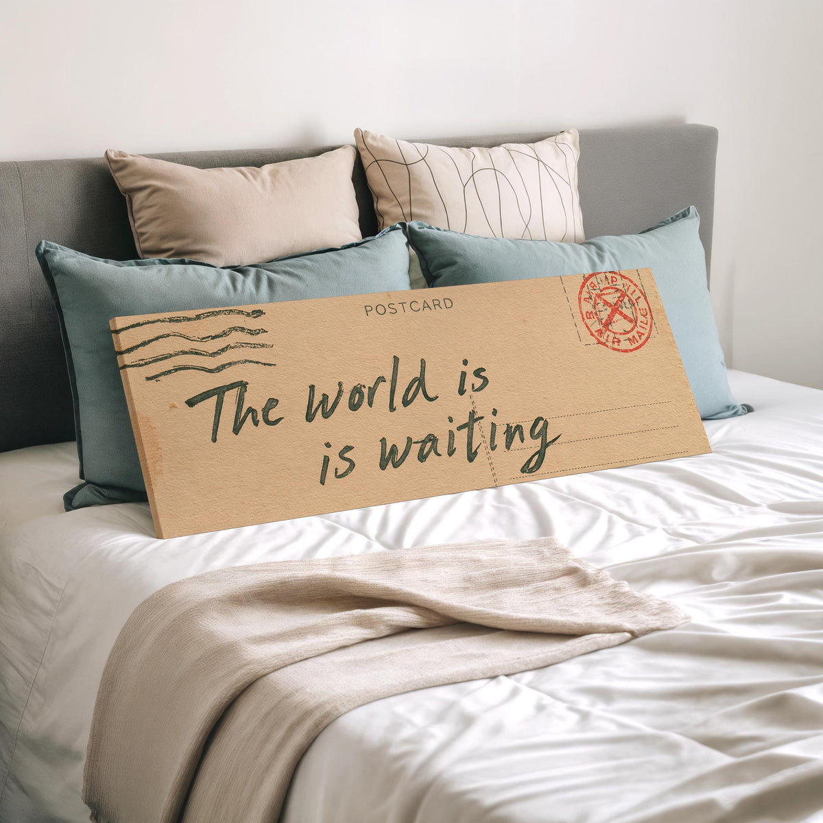 Vintage postcard saying the world is waiting wide panoramic canvas print laid on a bed to show its size