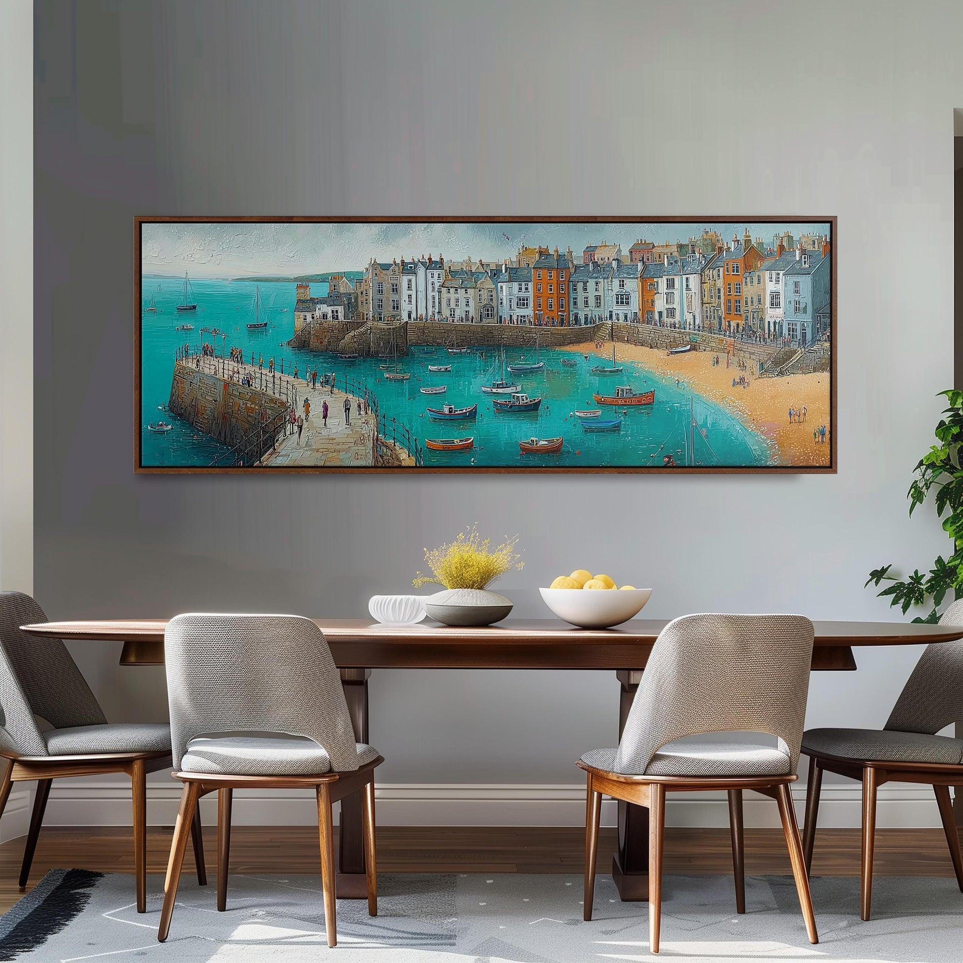 a large painting of a coastal town with boats on the water, hanging on a wall above a wooden dining table with four chairs.