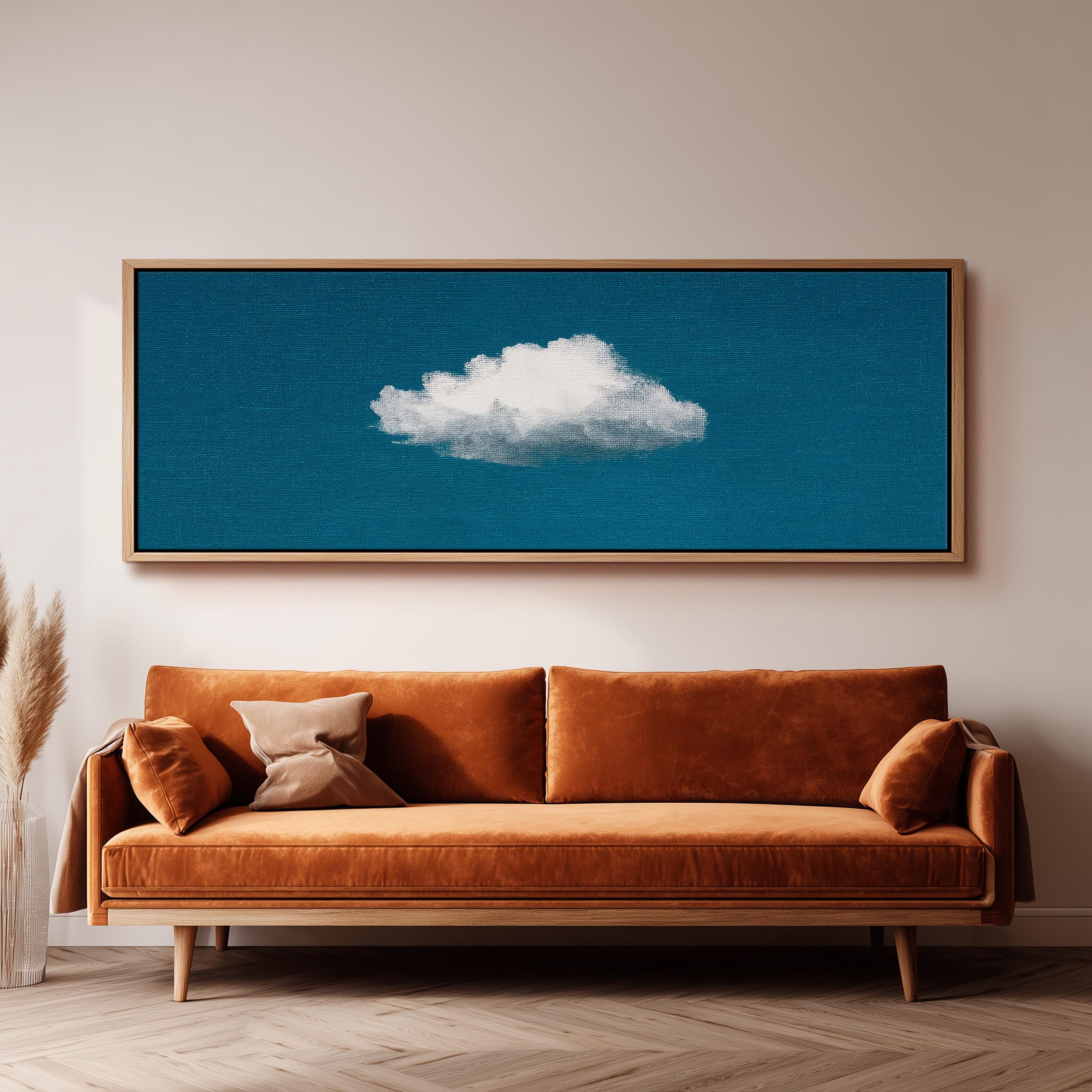 a cozy living room with a brown sofa and a framed artwork of a cloud on the wall above it.