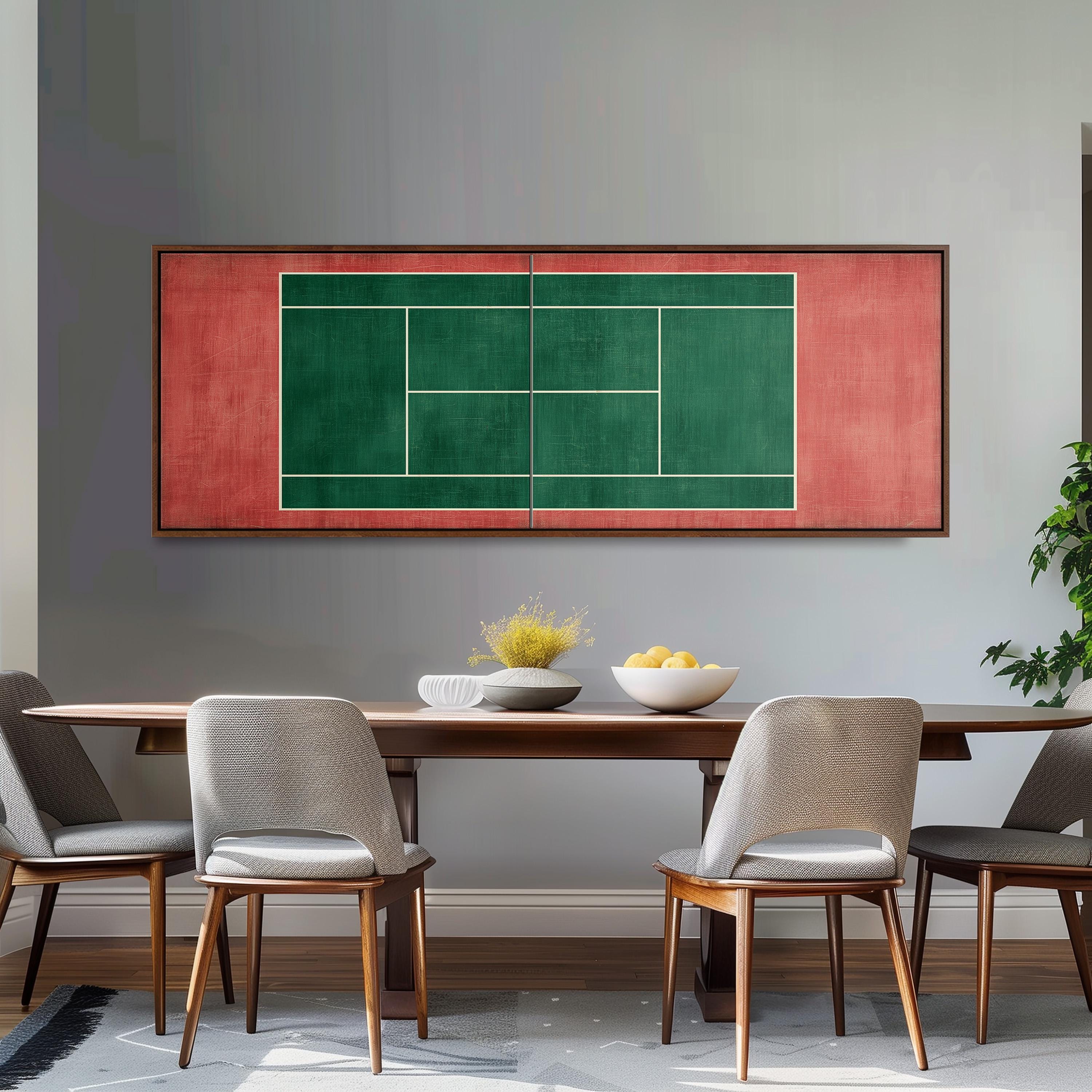 a dining room with a wooden table and four chairs. Above the table, there is a large framed painting of a tennis court in green and red colors. The painting is hanging on a gray wall. On the table, there is a bowl of fruit and a vase of flowers.