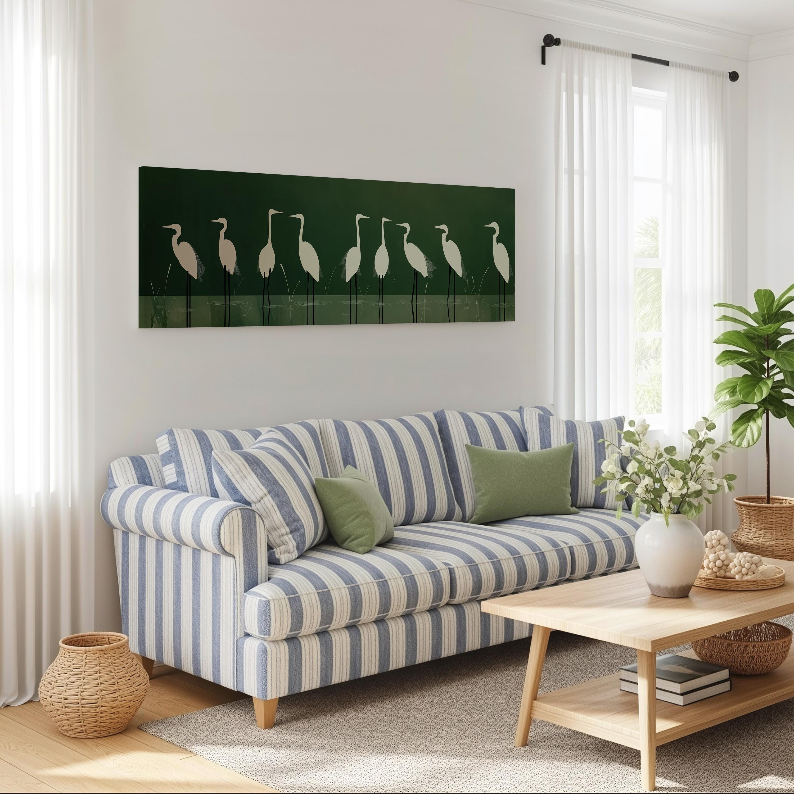 a cozy living room with a striped blue and white sofa, a wooden coffee table, and a large green wall art featuring a line of white birds.