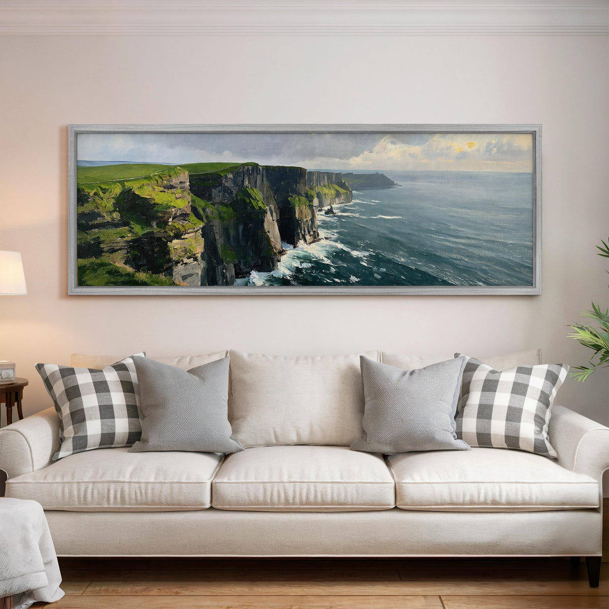 Emerald sea cliffs panoramic canvas print above a white sofa in a bright living room