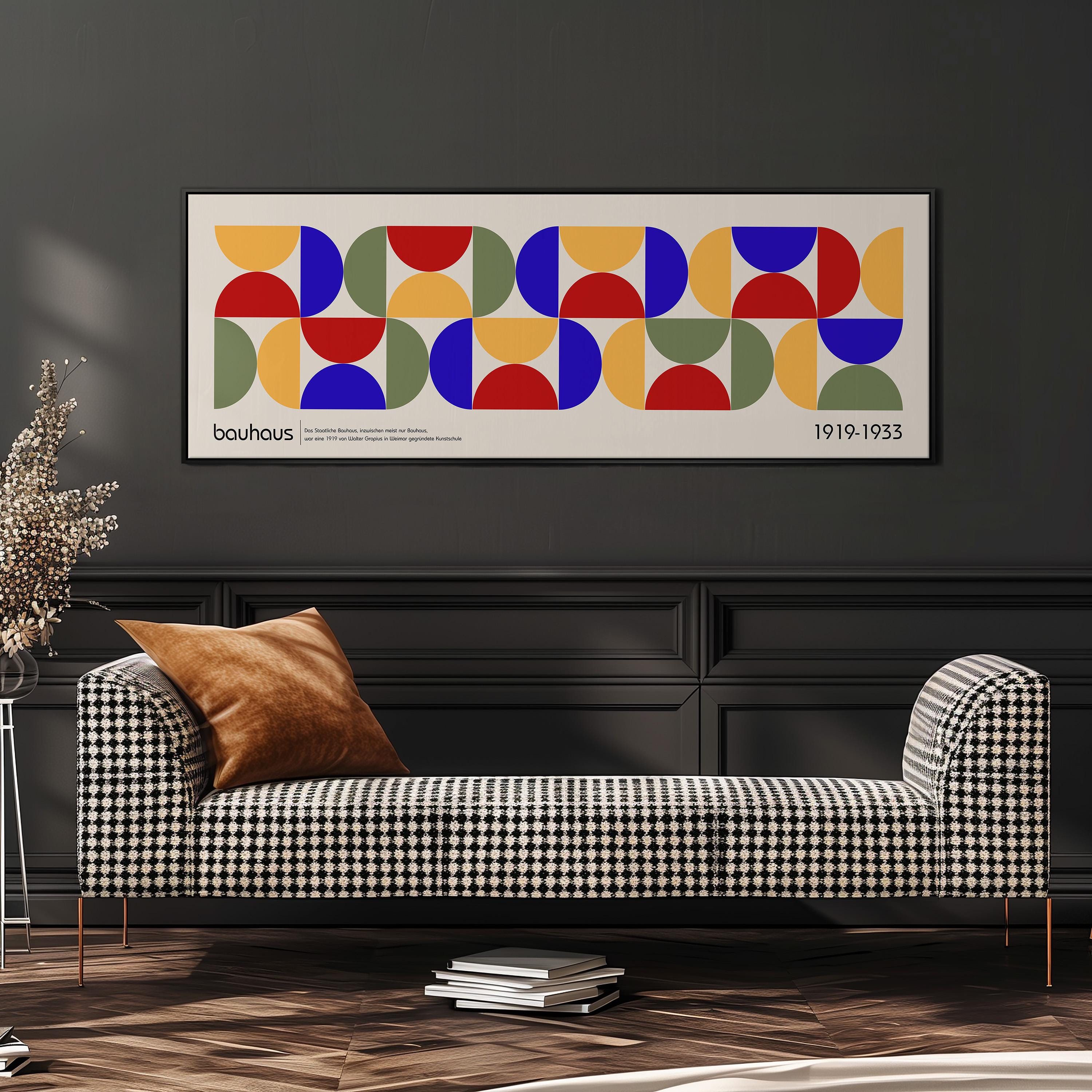a modern living room with a checkered sofa, a stack of books, and a large abstract art print hanging on the wall.