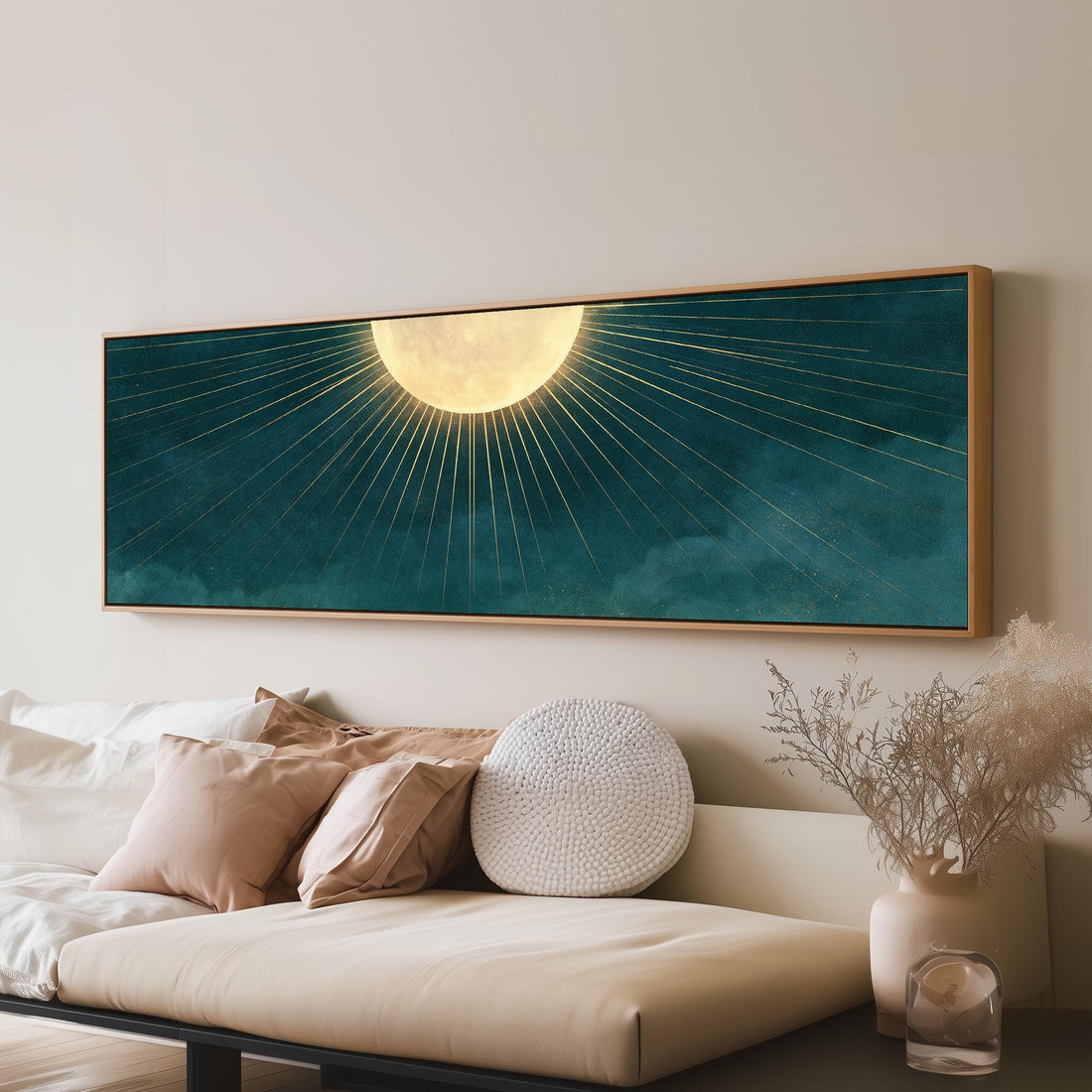 Golden sunburst moon on deep teal long horizontal canvas print above a sofa in a living room