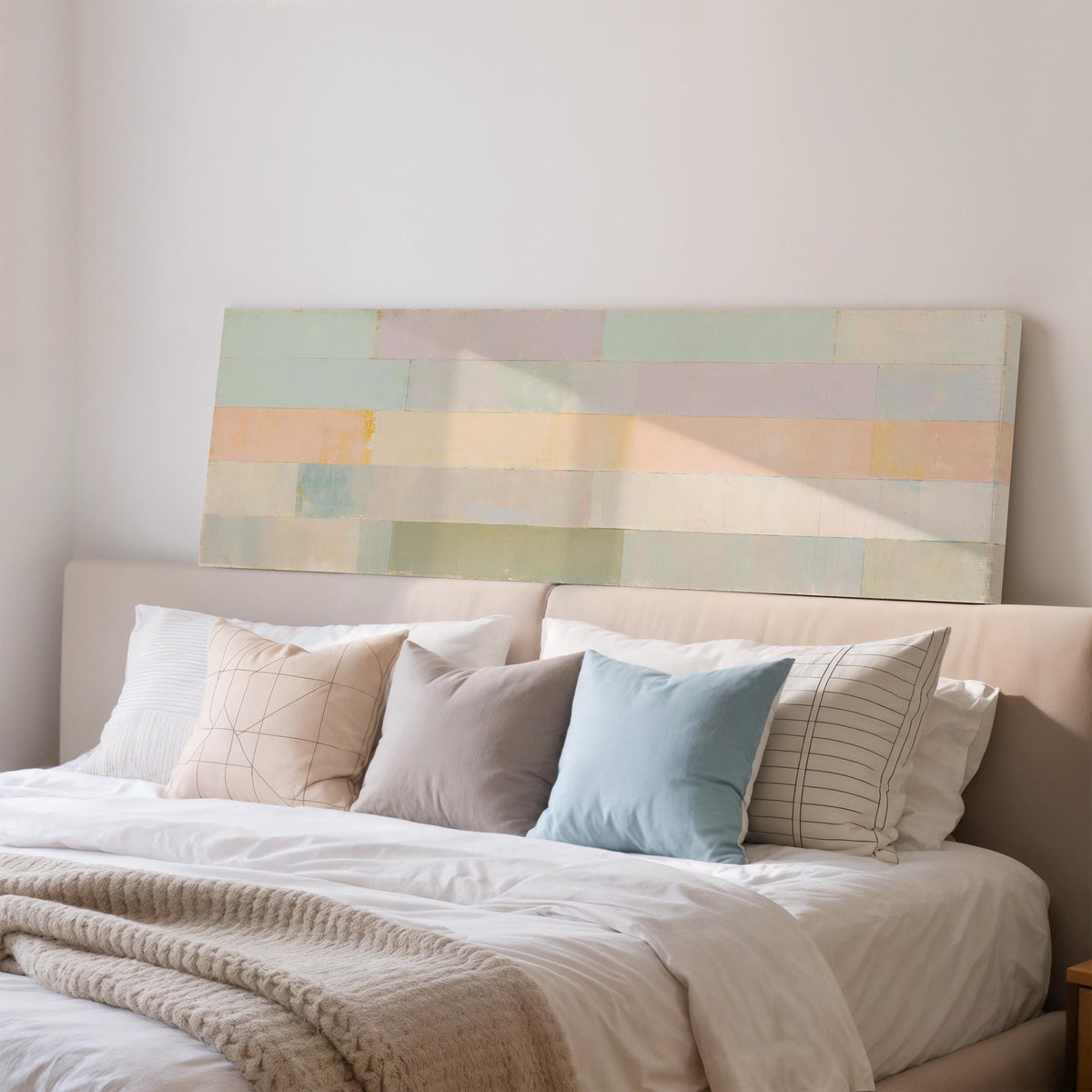 Soft lilac, mint and butter color bands wide panoramic canvas print above a bed in a bedroom