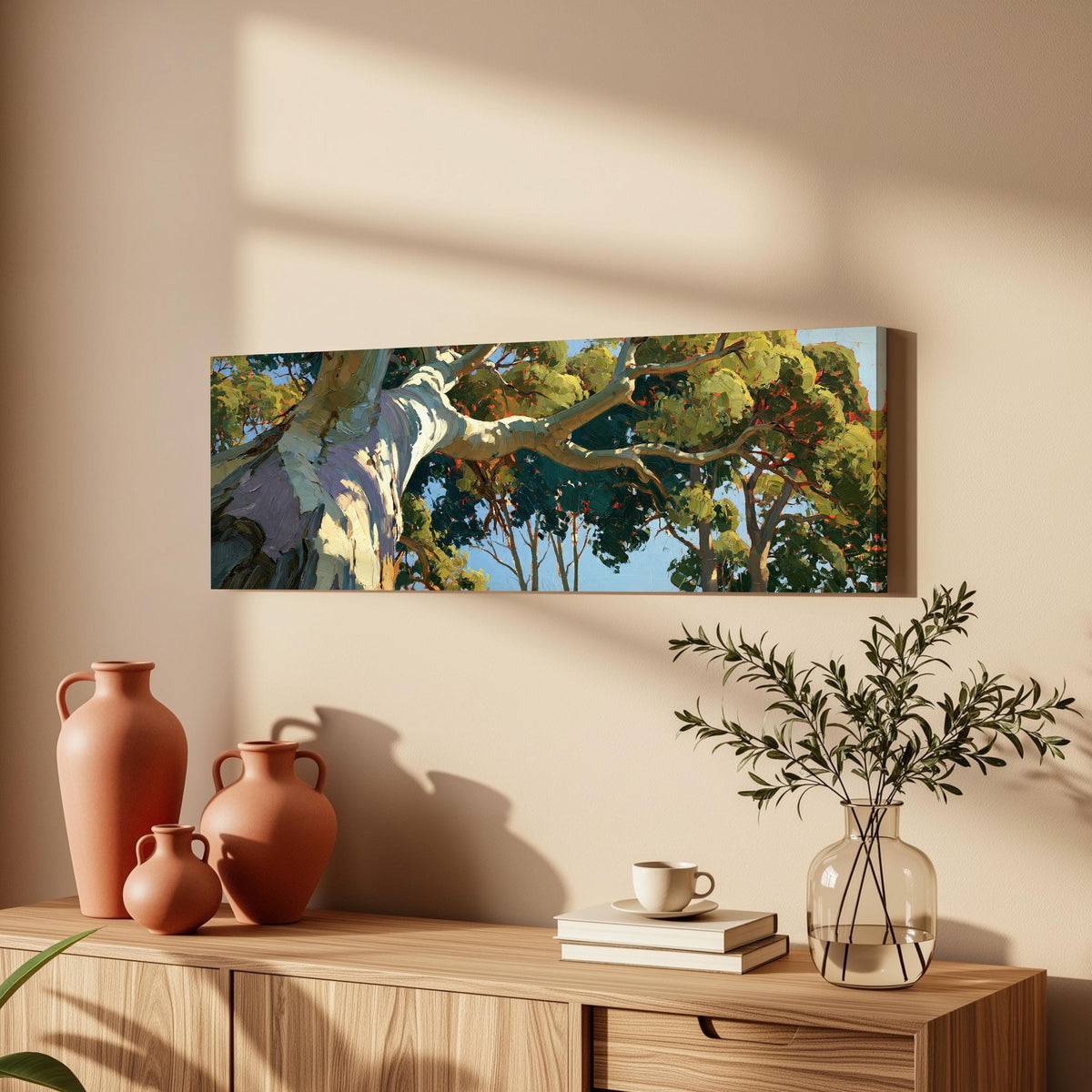 Sunlit eucalyptus trunk and branches long horizontal canvas print above a wooden sideboard