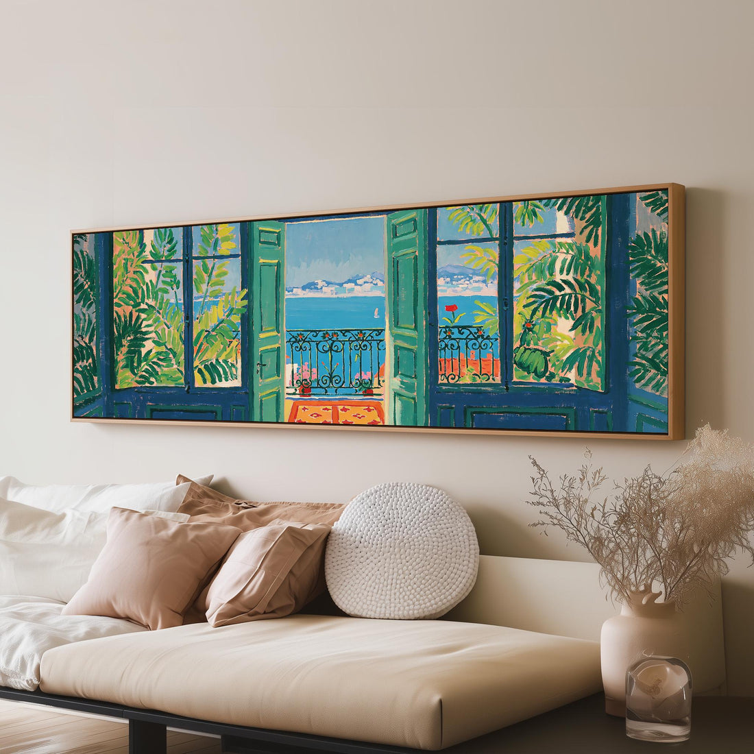 Riviera balcony view through open windows long horizontal canvas print above a sofa in a living room