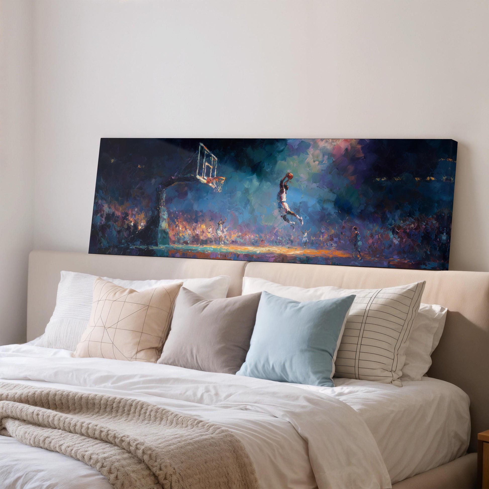 a large painting of a basketball player jumping in the air, displayed on a wall above a bed with white pillows and a gray blanket.