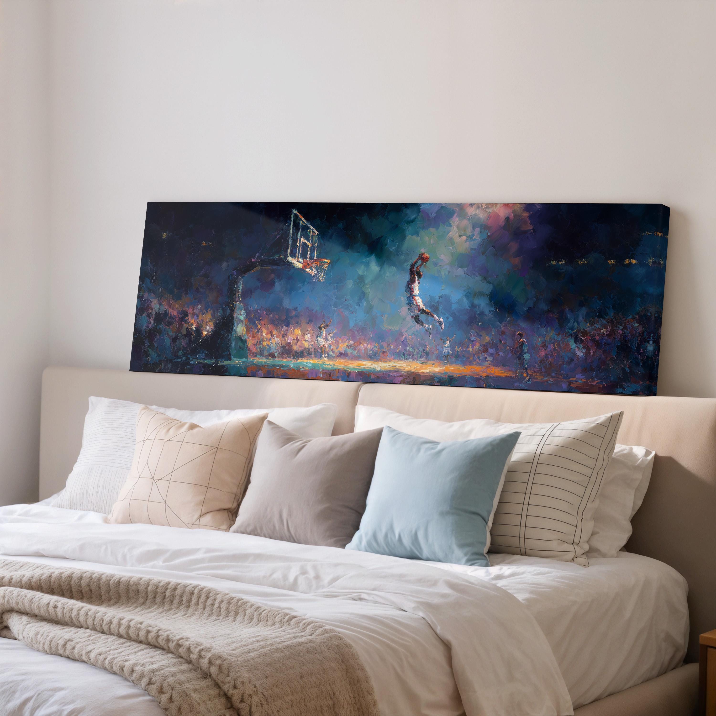a large painting of a basketball player jumping in the air, displayed on a wall above a bed with white pillows and a gray blanket.