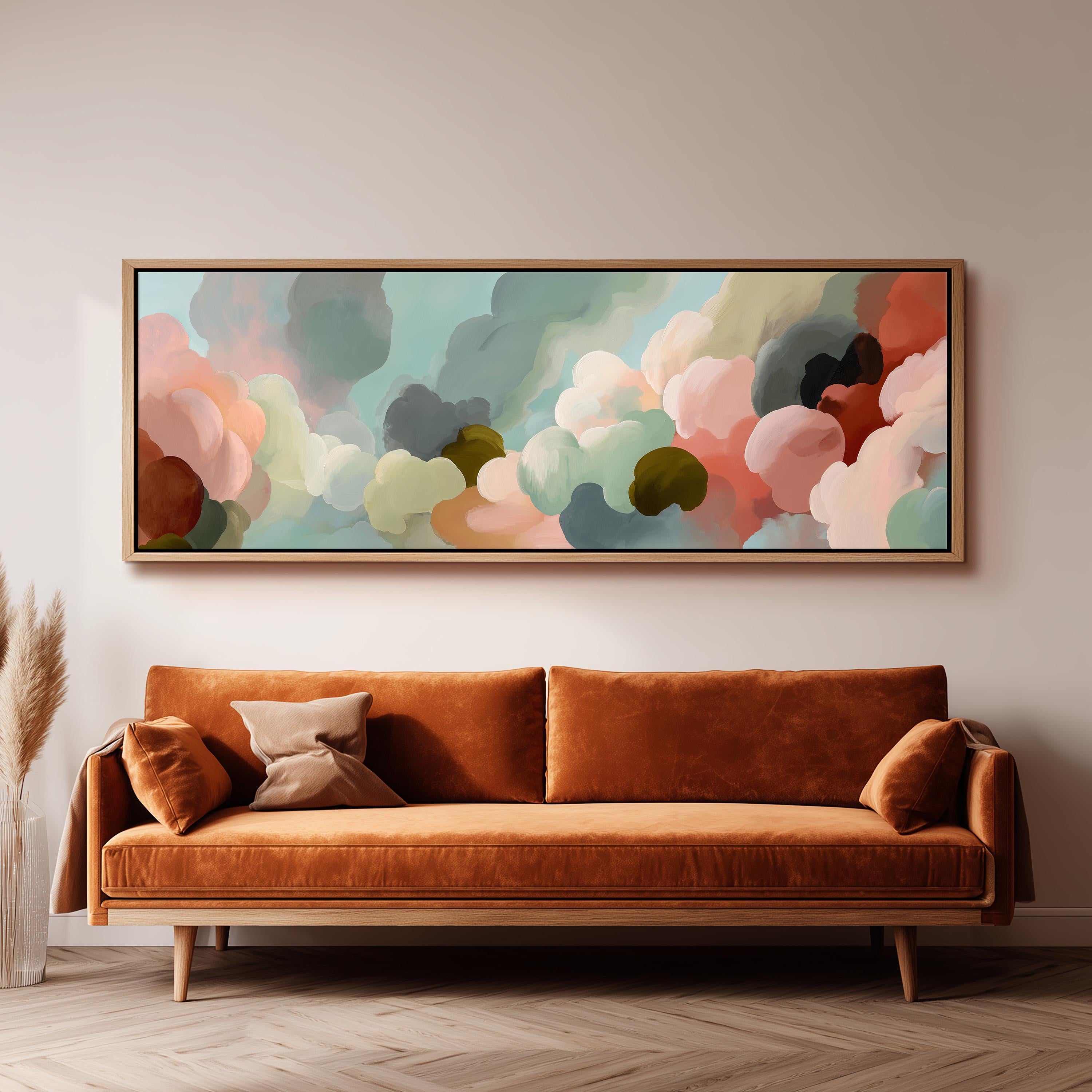 a large, abstract painting hanging on a wall above a brown sofa with two pillows.
