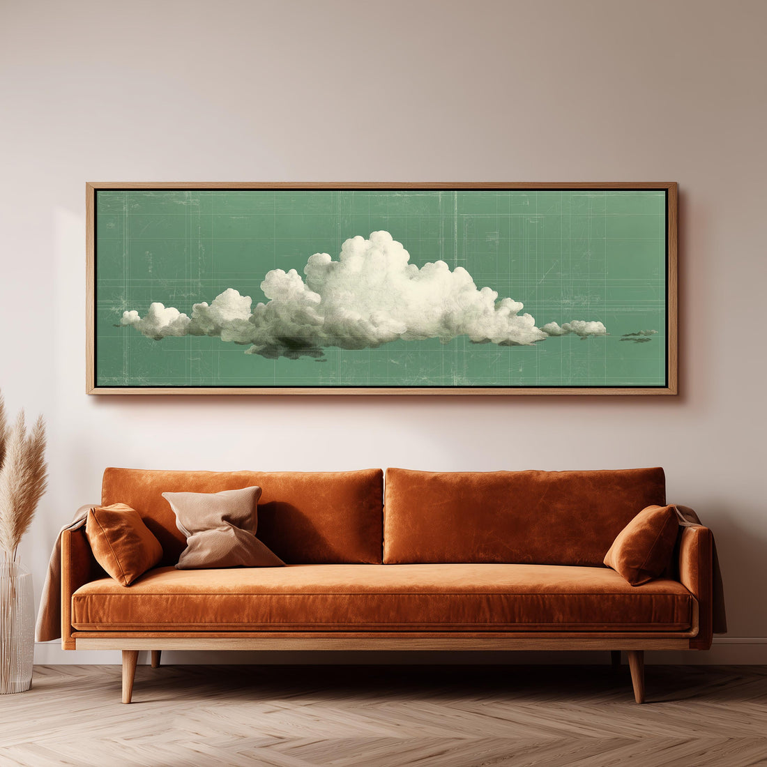 a large framed artwork depicting a cloud on a green background, hanging on a wall above a brown sofa with two pillows.