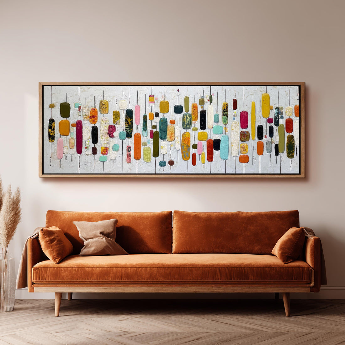 a large, abstract painting hanging on a wall above a brown sofa.
