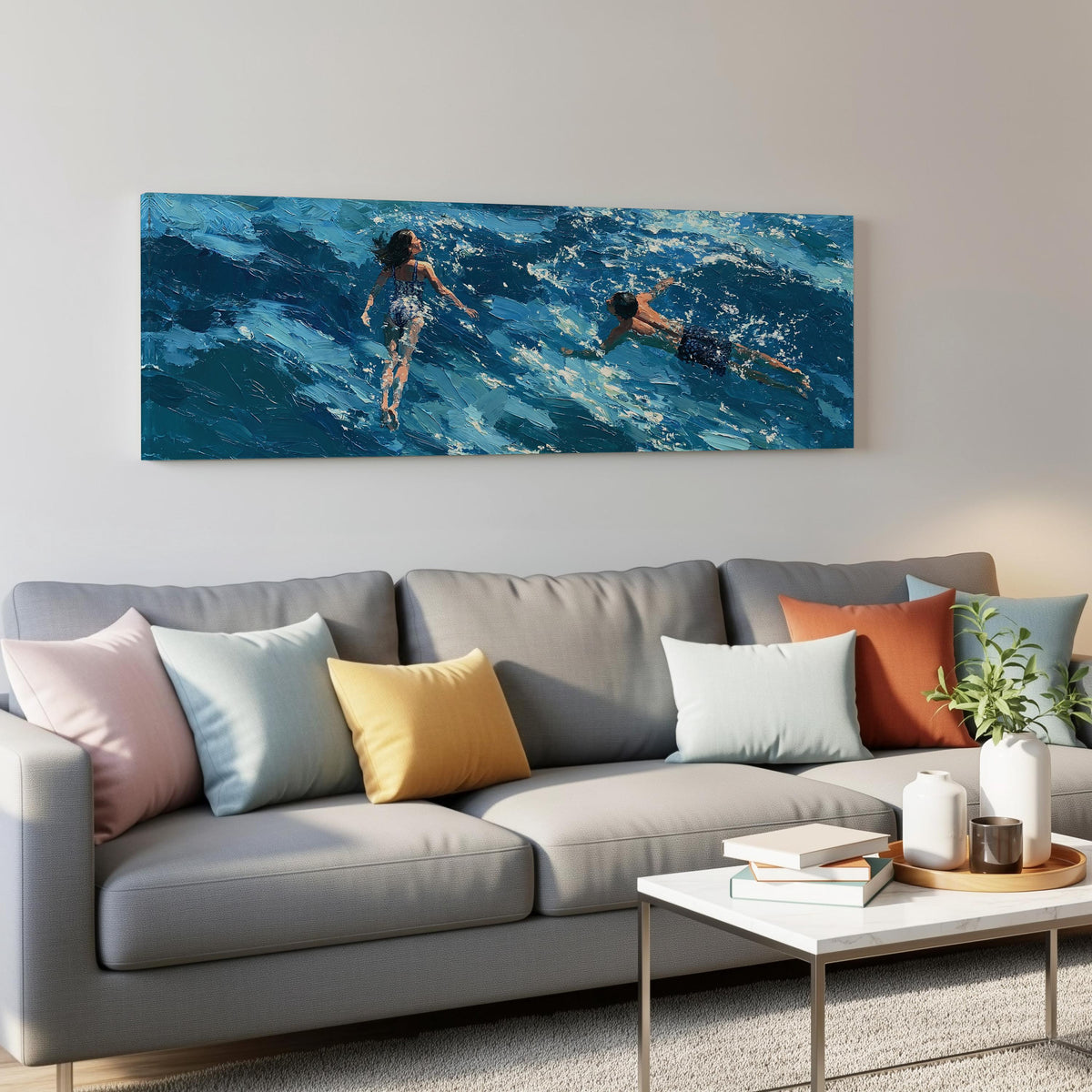 Two swimmers in turquoise waves panoramic canvas print above a grey sofa in a living room