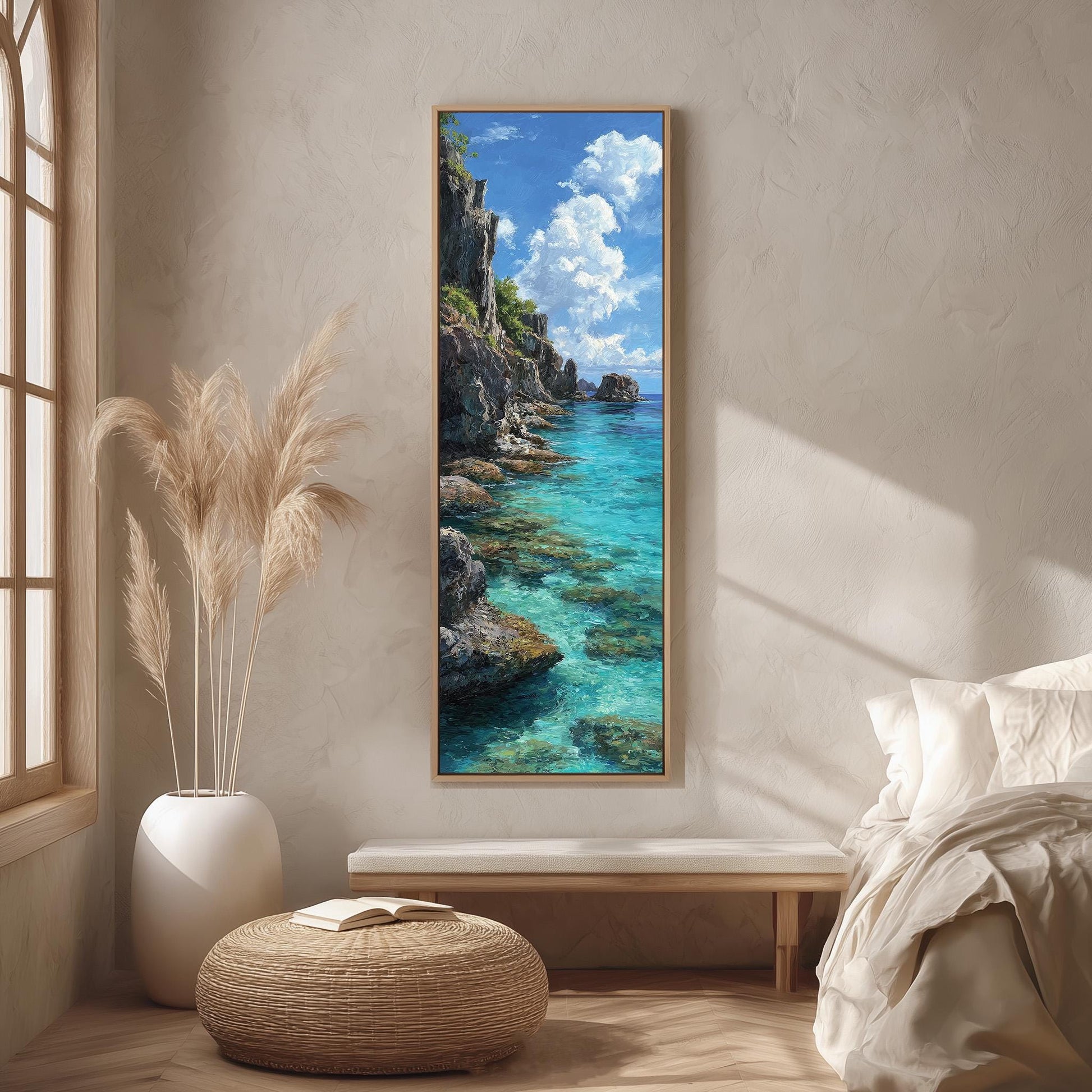 a serene bedroom scene with a large painting of a picturesque ocean landscape hanging on the wall. The painting showcases a rocky cliff overlooking a turquoise sea, with a clear blue sky dotted with fluffy white clouds. The room is decorated with a white bed, a wicker ottoman, and a potted plant, creating a cozy and inviting atmosphere.