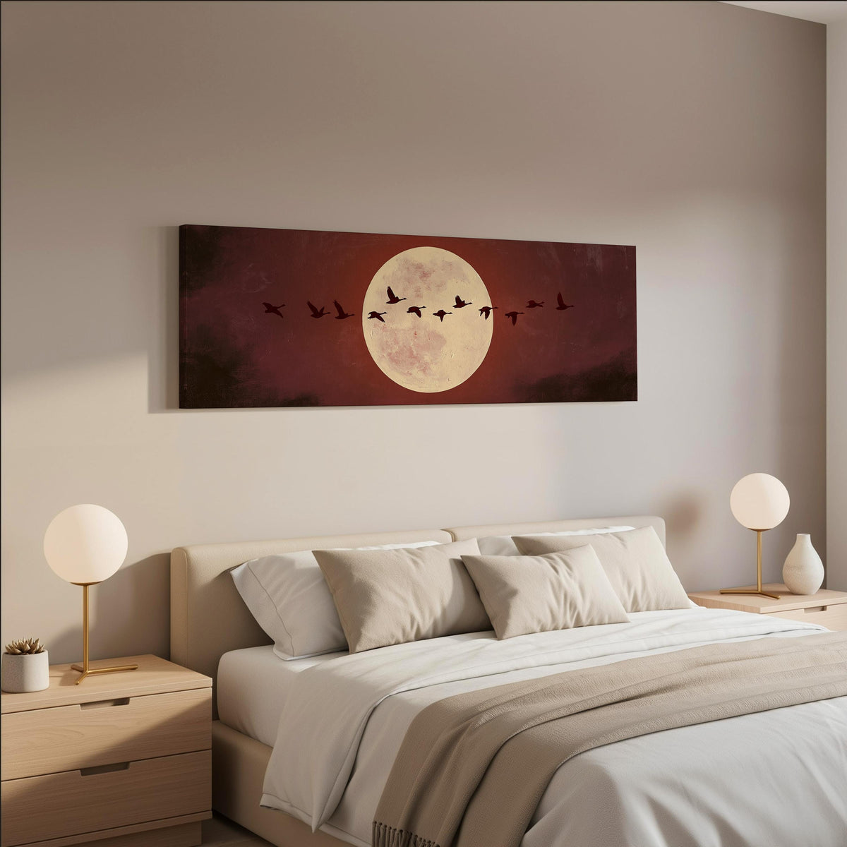 Geese crossing a pale moon on maroon wide panoramic canvas print above a bed in a neutral bedroom