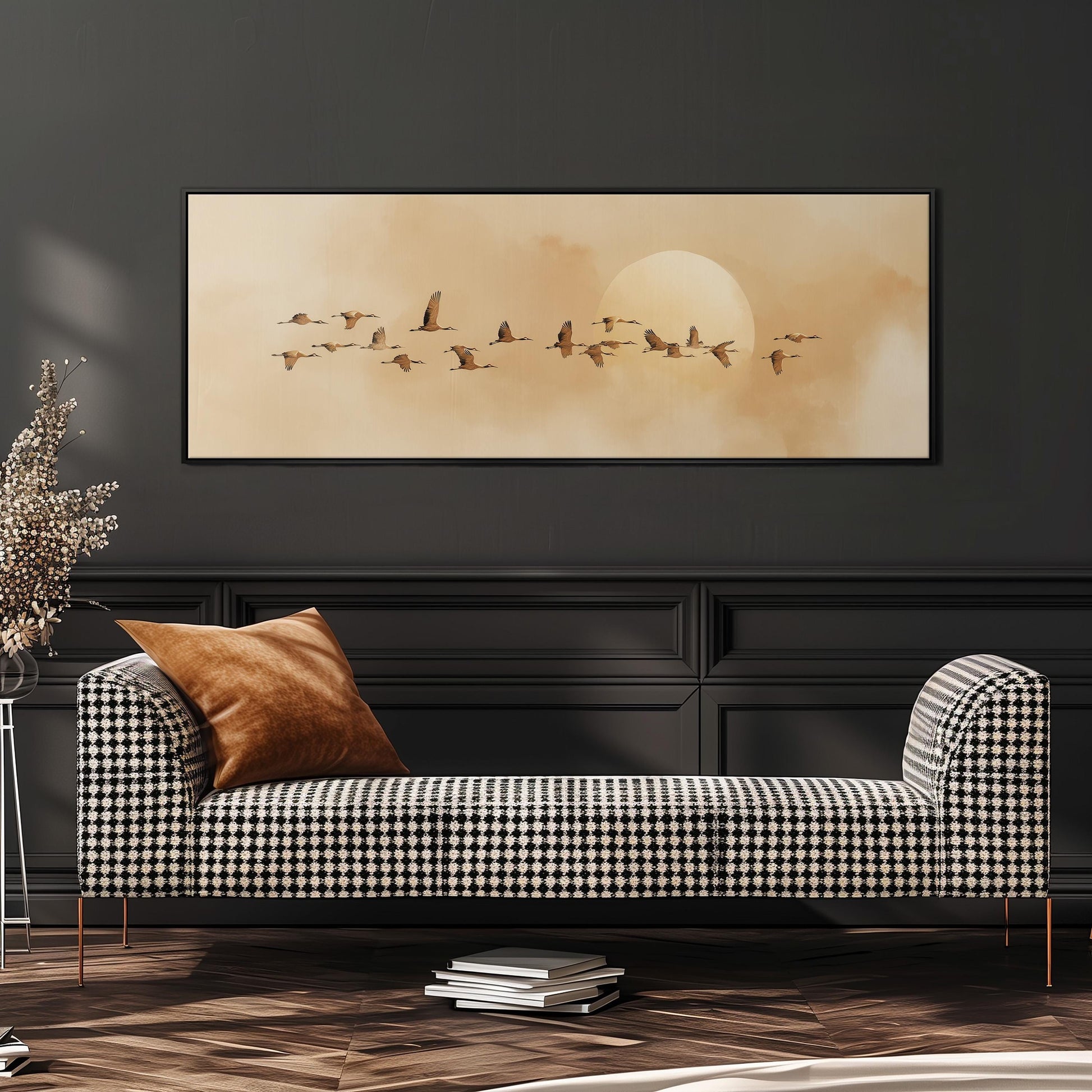 a black and white checkered sofa with a brown throw pillow, set against a dark wall with a framed painting of a flock of birds flying in the sky above it.