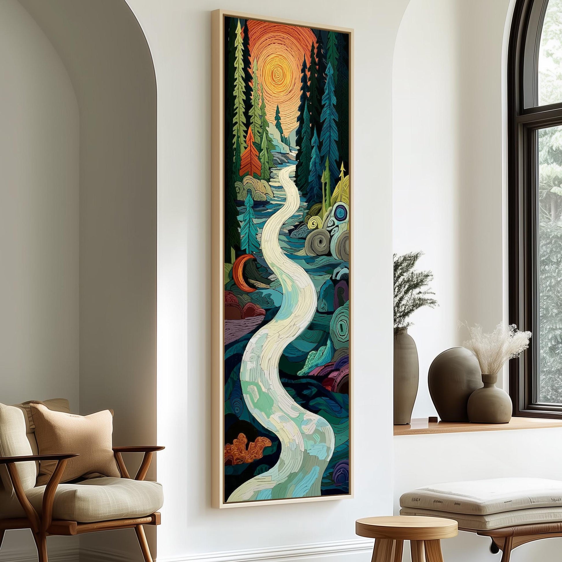 a large, colorful painting of a winding river surrounded by a forest, with a warm, orange sun in the sky. The painting is hanging on a white wall, and there are two chairs and a small table in the foreground.