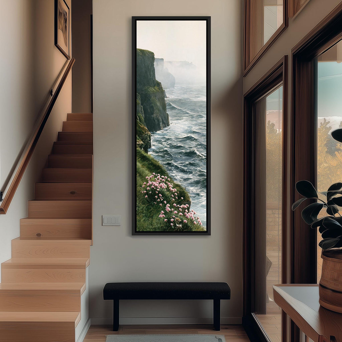 Misty sea cliffs with pink wildflowers tall narrow canvas print beside a staircase in an entryway