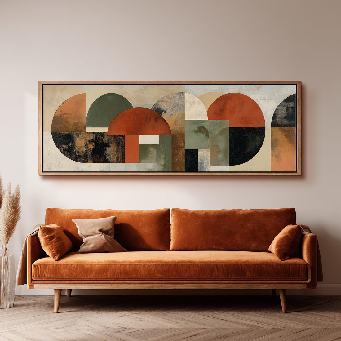a large abstract painting hanging on a wall above a brown sofa with two pillows.