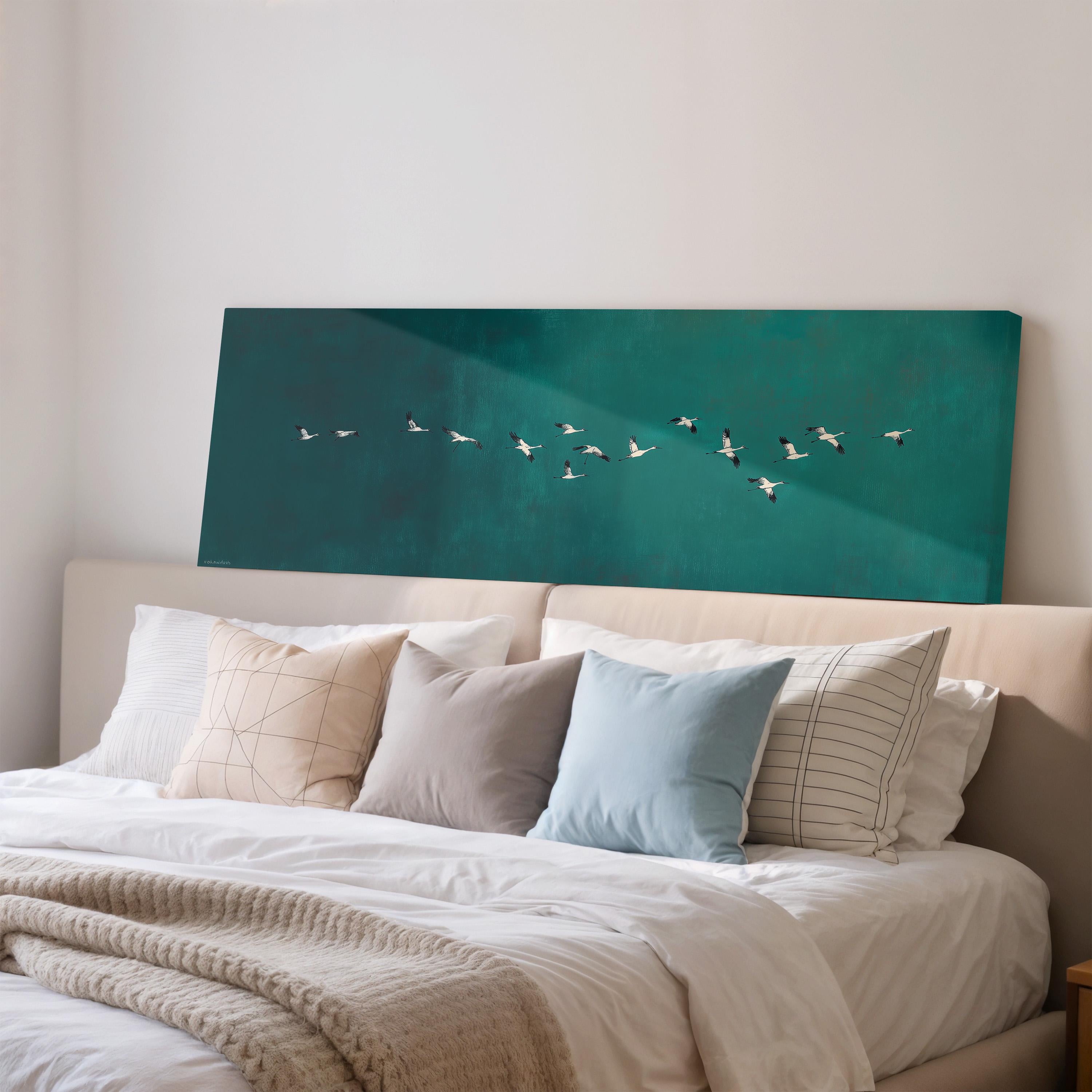 a bedroom with a large bed covered in white sheets and pillows. Above the bed, there is a large canvas print depicting a flock of birds flying across a green background.