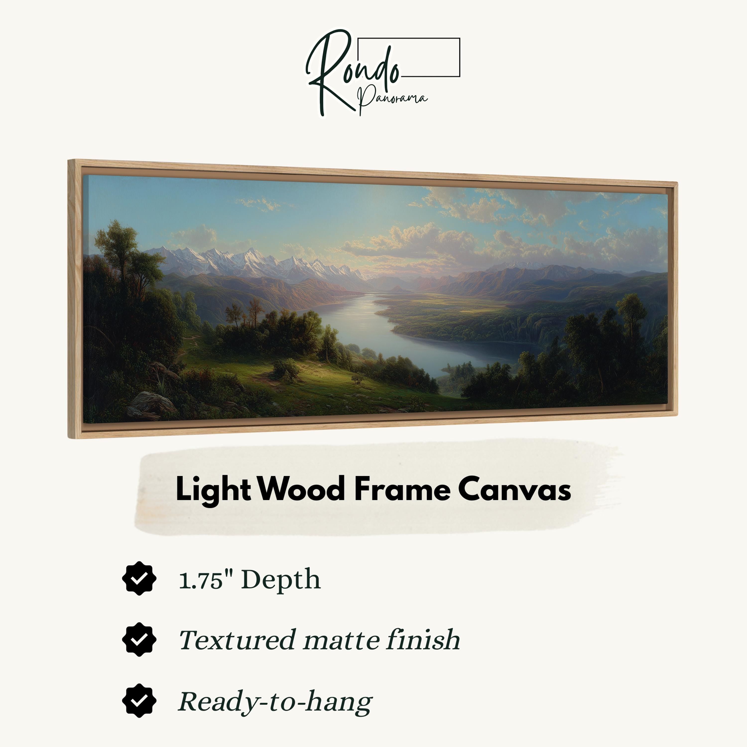 The image is a light wood frame canvas depicting a landscape with mountains, trees, and a river.
