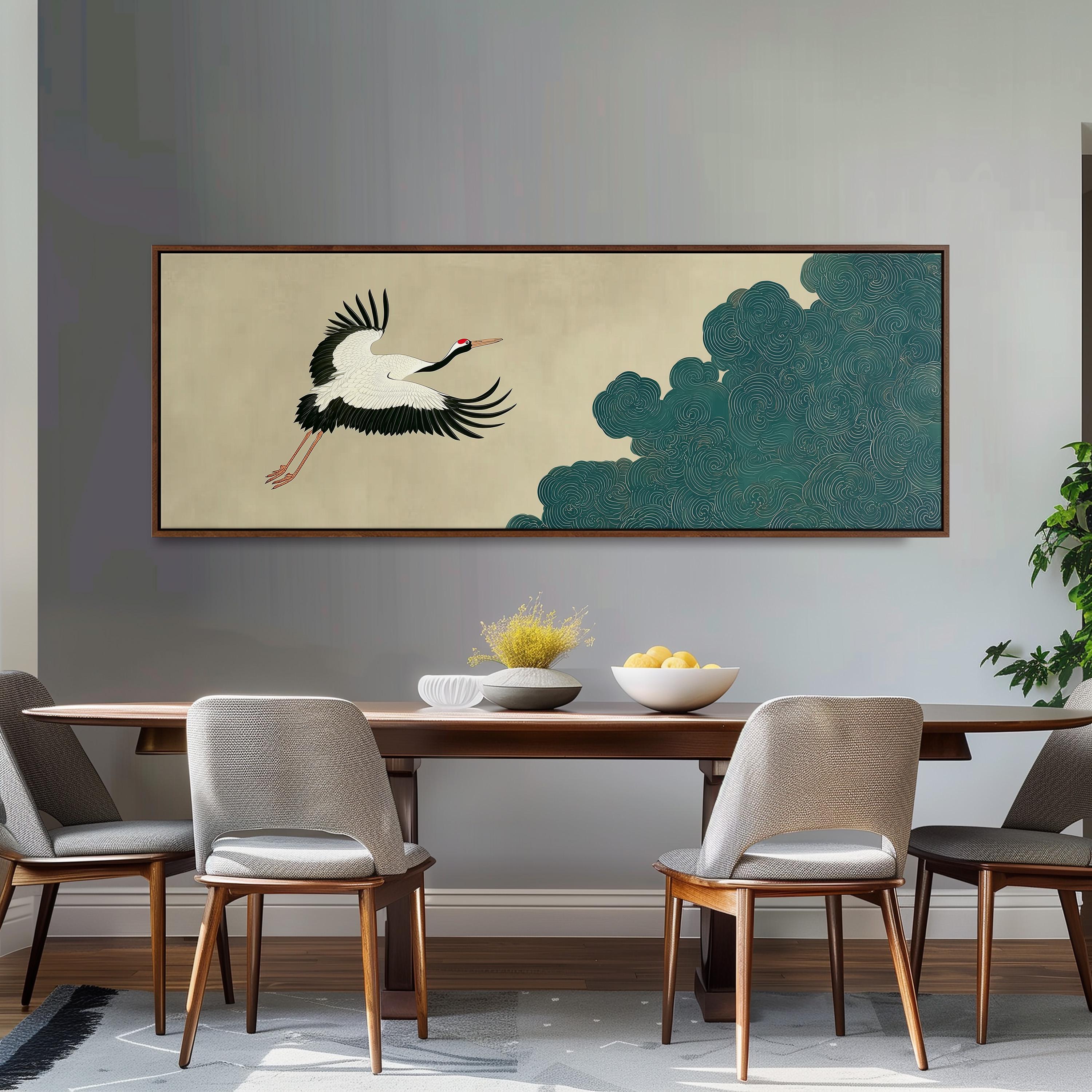 a dining room with a wooden table and four chairs. Above the table, there is a large painting depicting a crane in flight. The painting is framed and hangs on the wall. The table is set with a bowl of fruit and a vase of flowers, creating a welcoming and elegant atmosphere.