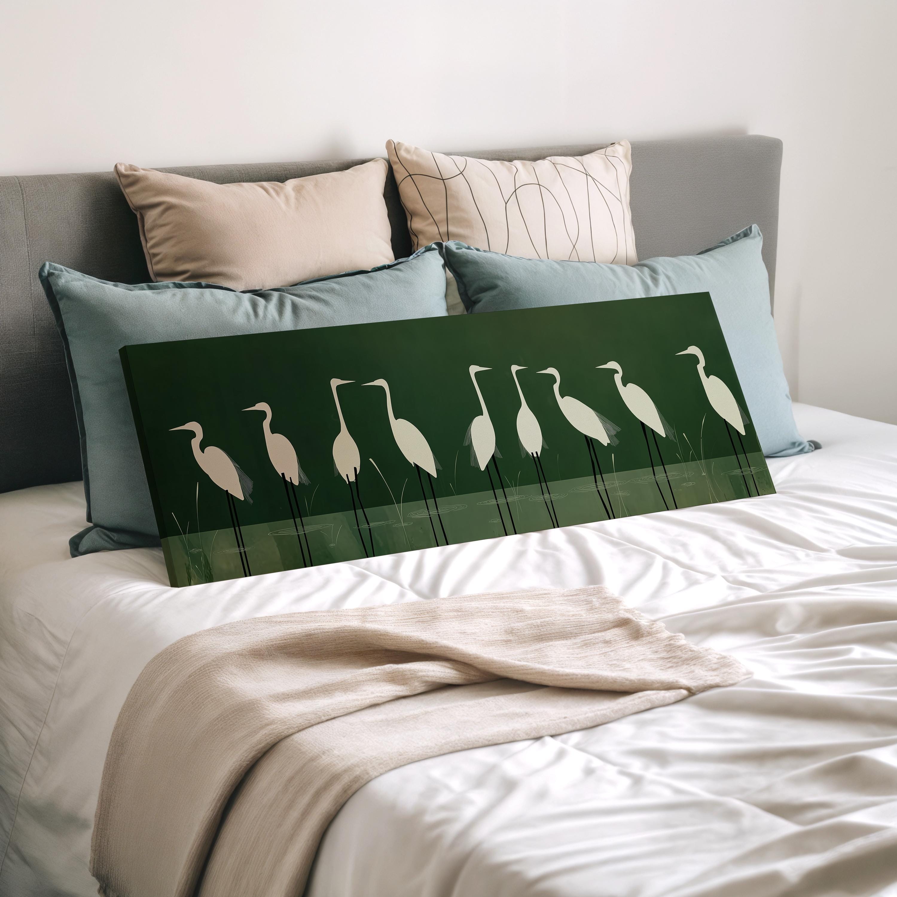 a bed with a green and white artwork of a group of white birds on a bedspread.