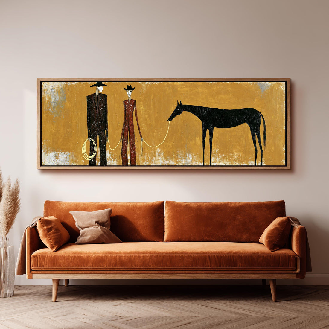 Two cowboys with a dark horse on gold long horizontal canvas print above a sofa in a living room