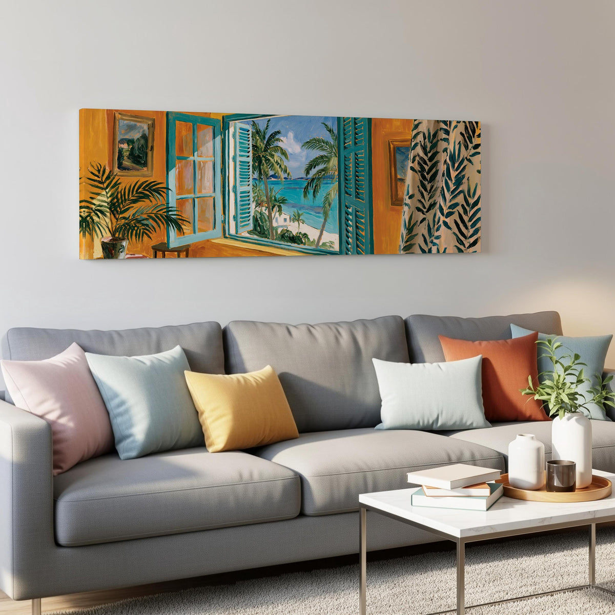 Beach house window overlooking palms and sea panoramic canvas print above a grey sofa in a living room