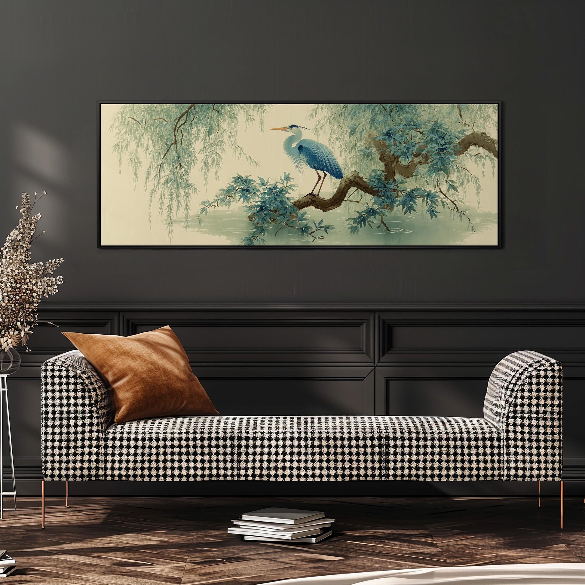 a large, framed painting of a blue heron perched on a branch, hanging on a wall above a black and white checkered sofa.